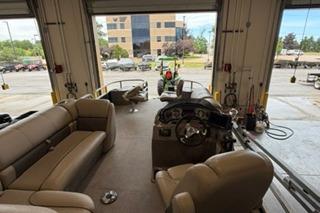 2022 Sun Tracker Fishin' Barge 22 DLX interior in a garage setting.