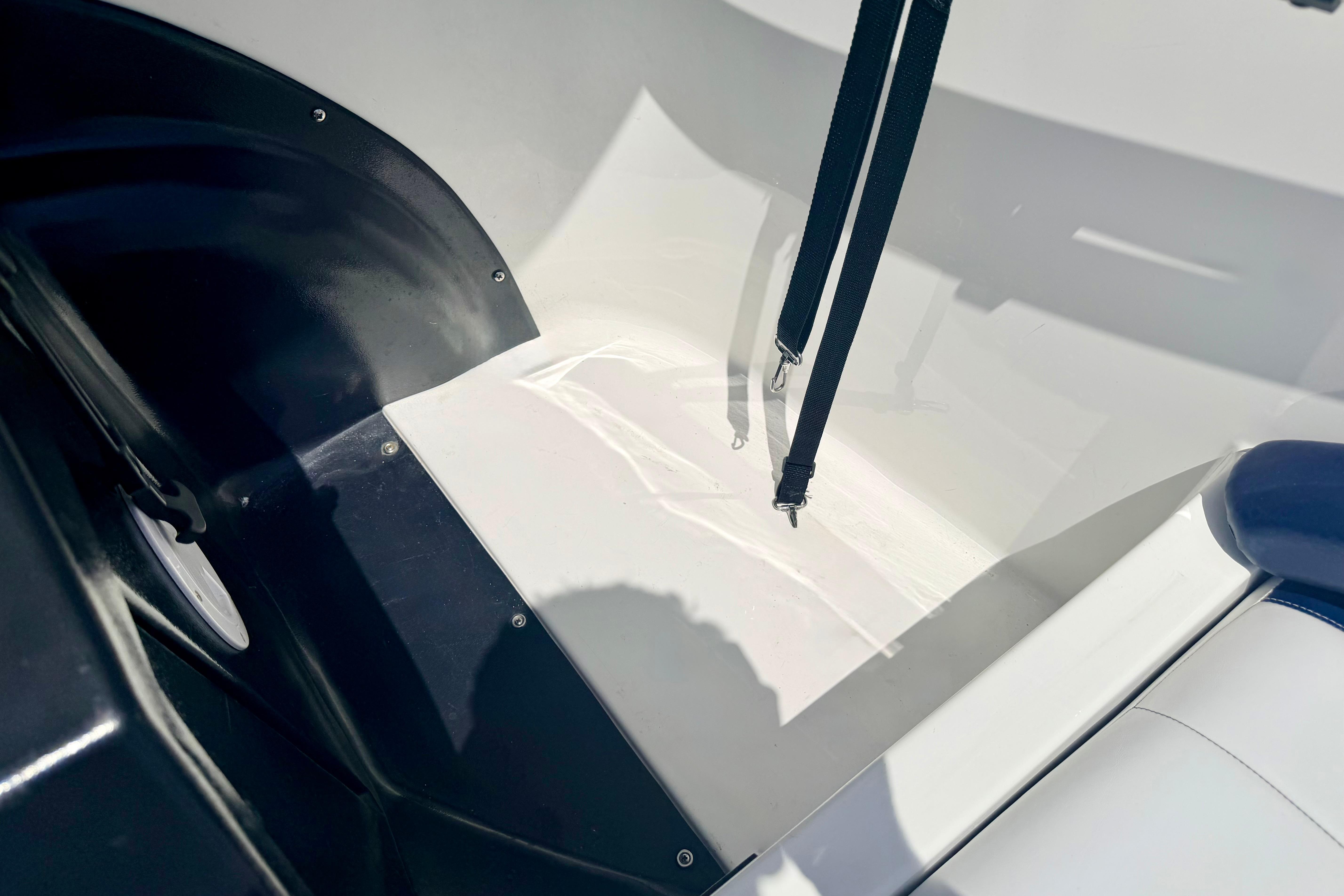 Interior view of a 2004 Bombardier SEADOO Utopia 185 boat, featuring seating and straps.