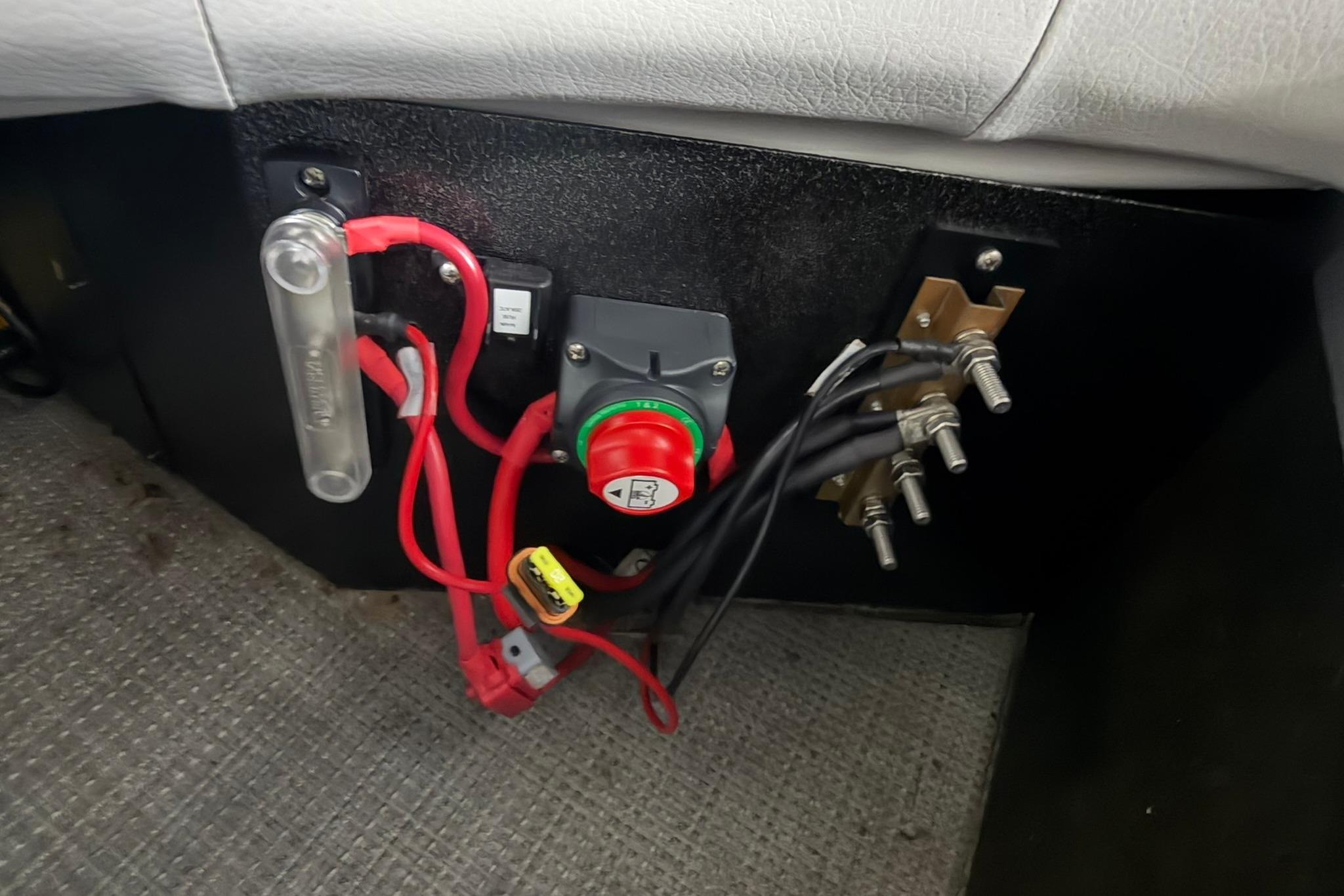 Electrical panel with switches and wiring in a 2023 Crest Classic LX 200 boat.