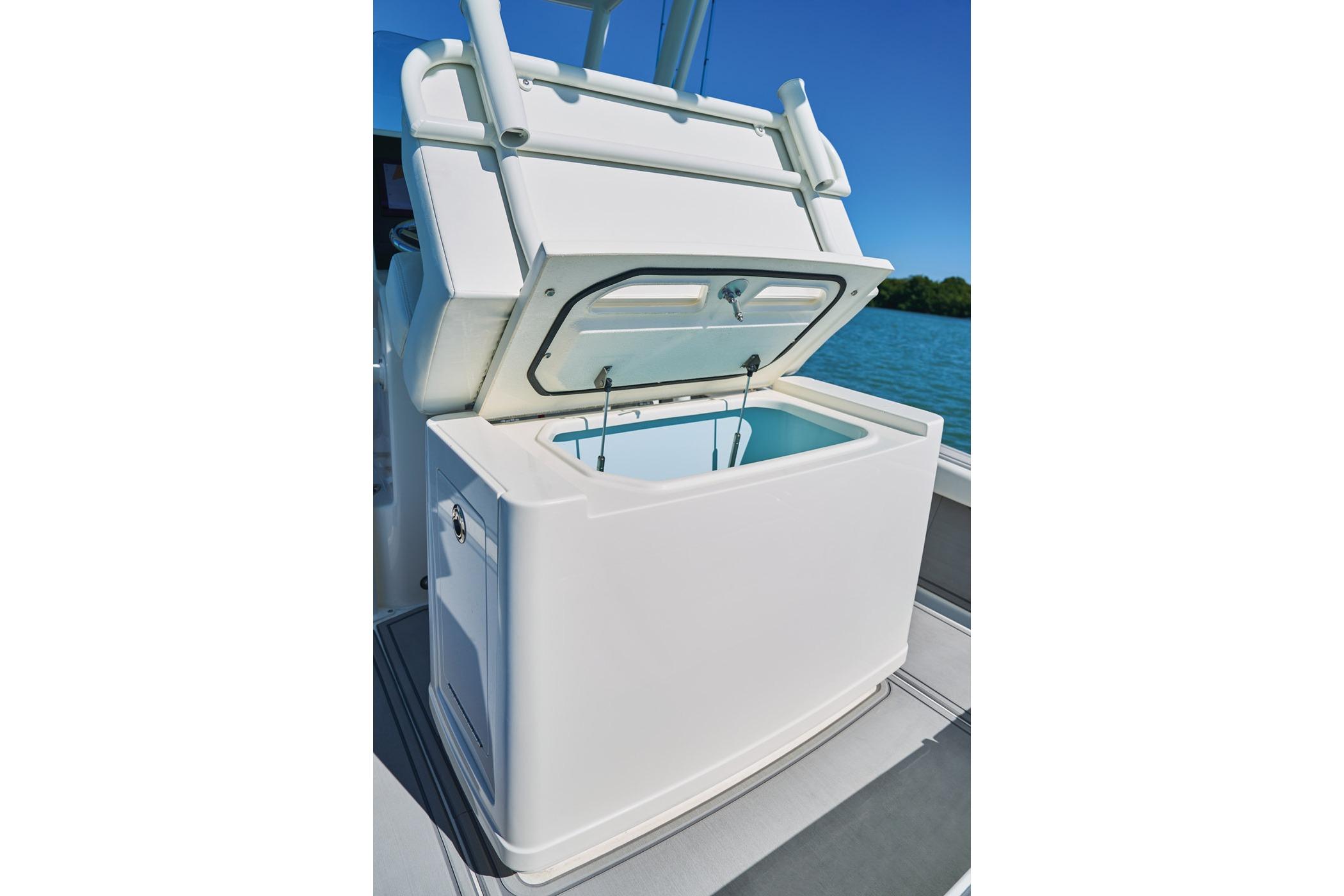 2026 Mako 24 APEX boat with open storage compartment on deck.