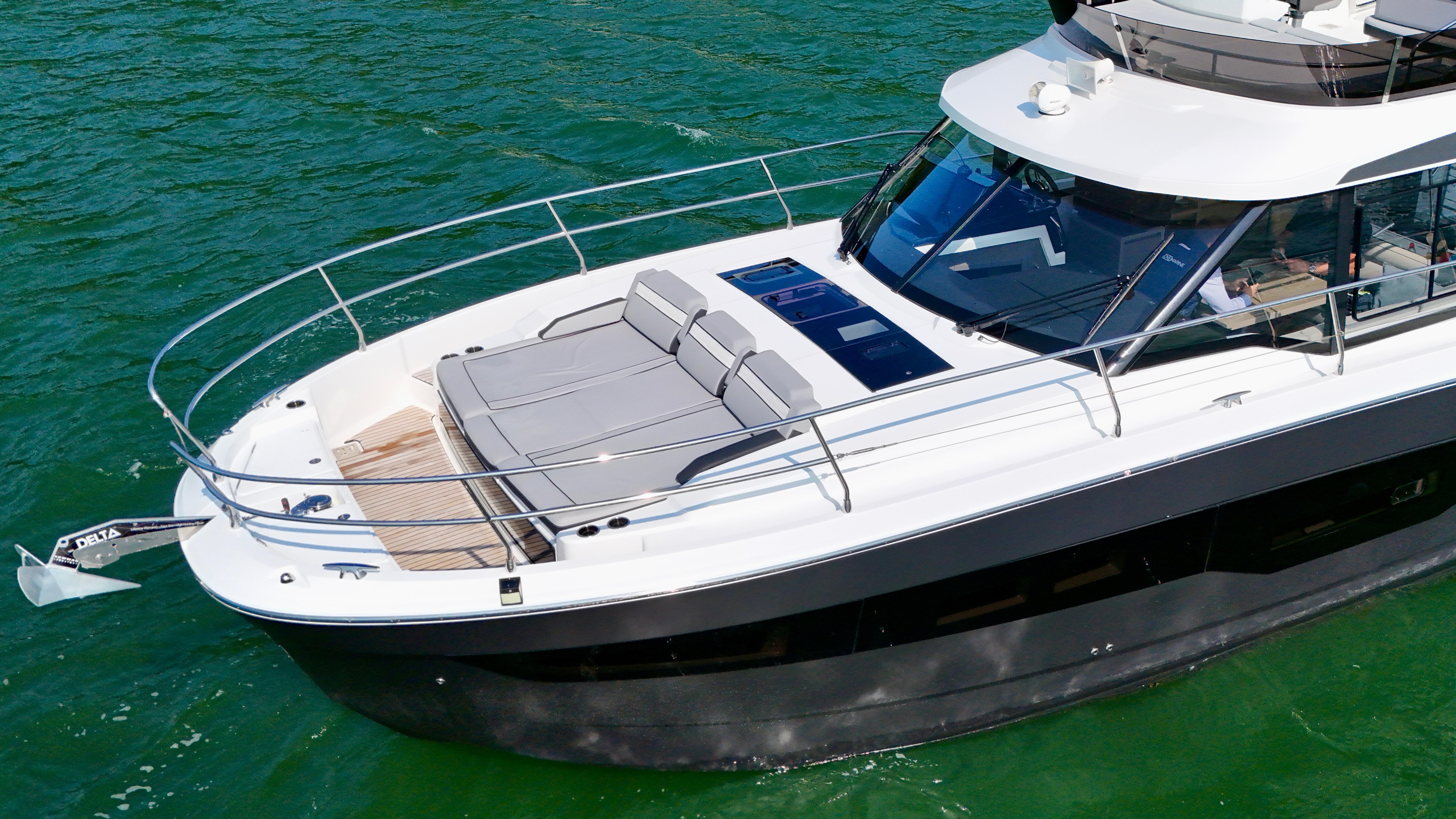2024 Jeanneau Merry Fisher 1295 Flybridge yacht on water, featuring spacious deck and sleek design.