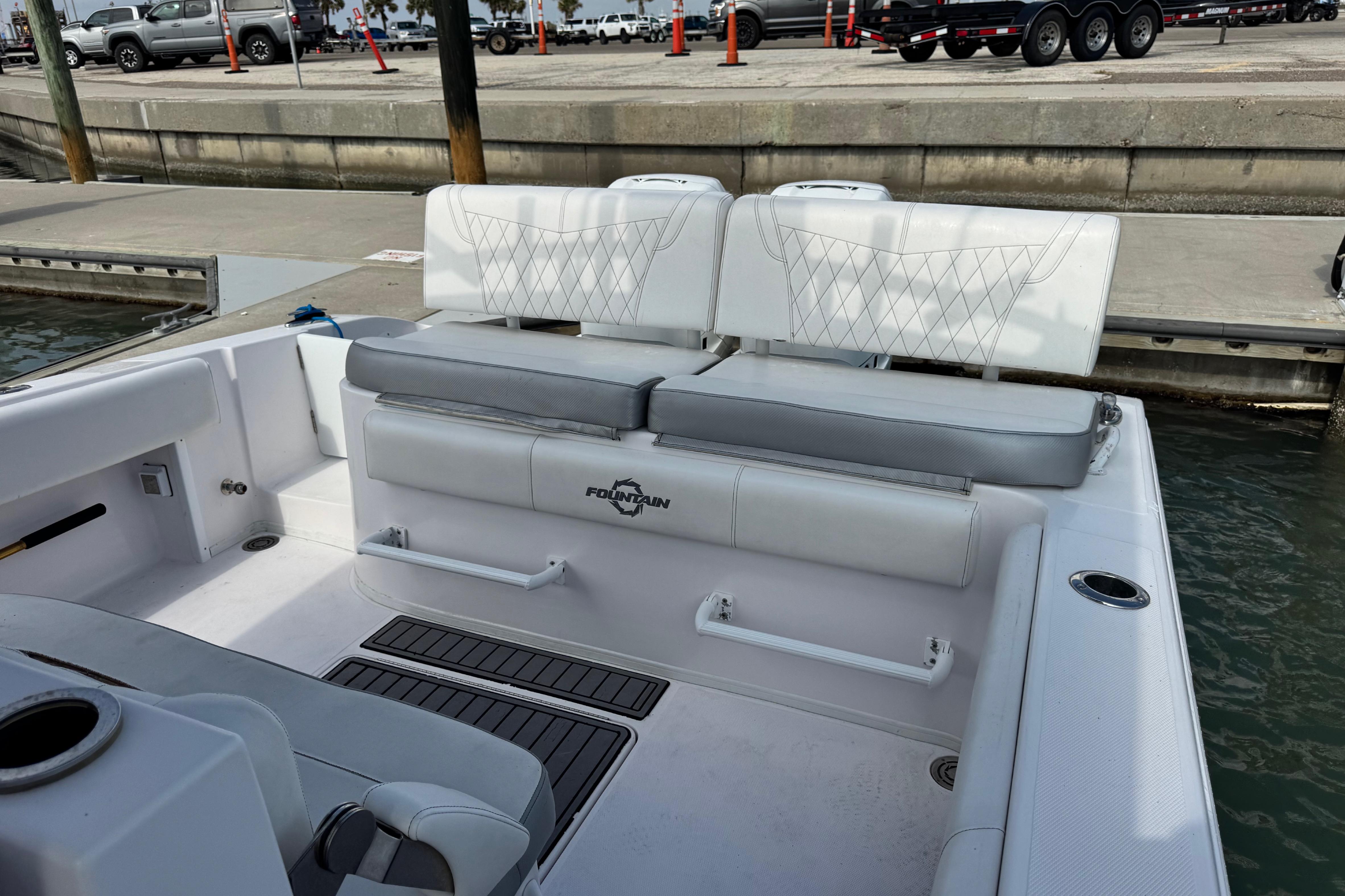 2018 Fountain 34 Center Console boat interior with white seating at dock.
