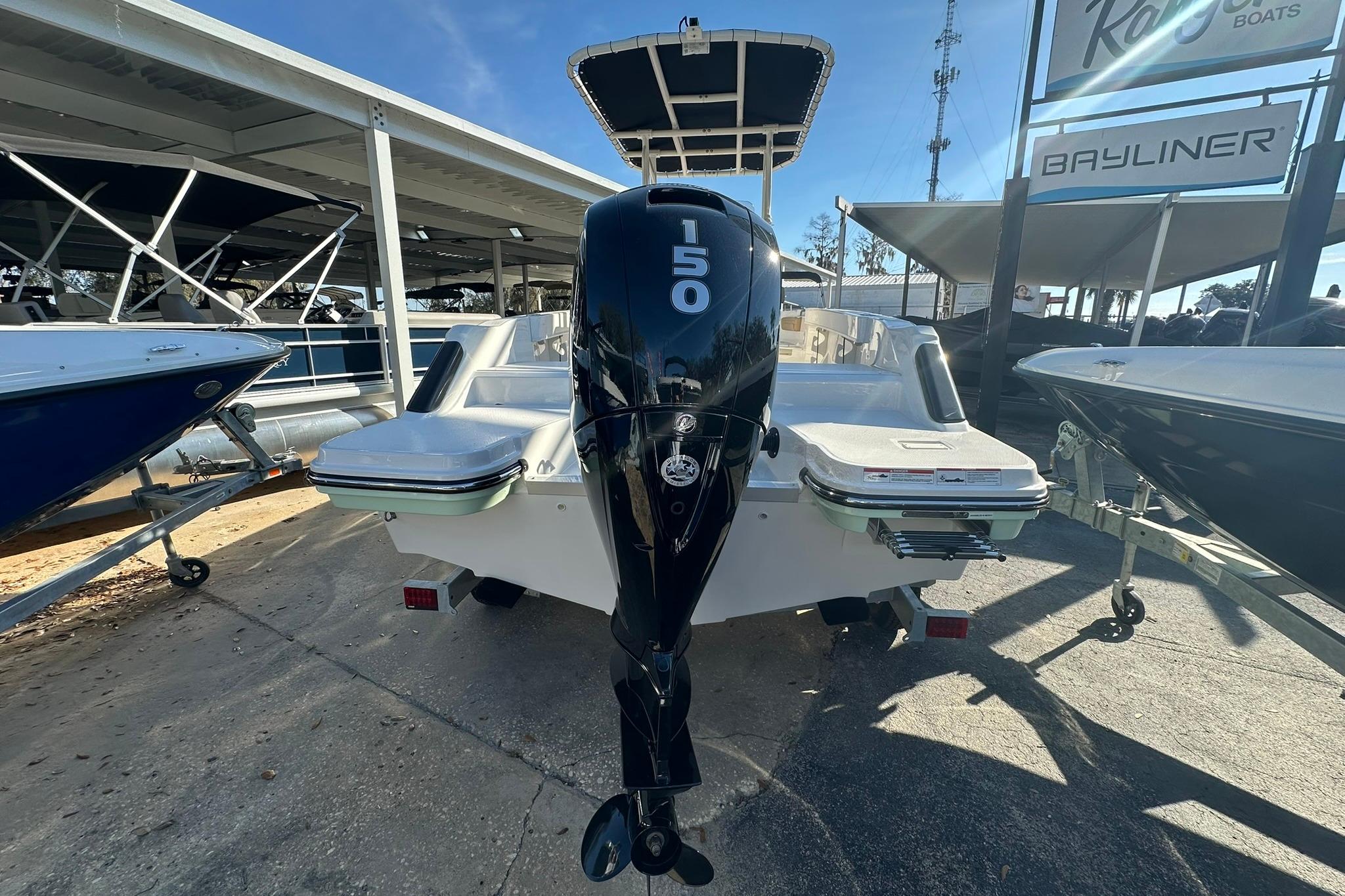 2026 Bayliner Trophy T20CC boat with 150 horsepower outboard motor, displayed at a dealership.