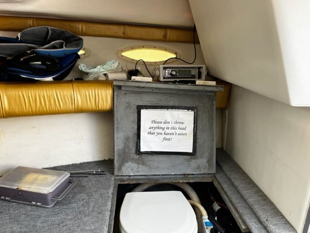 Interior of a 1998 Sport-Craft 252 SPORT FISH with a toilet and storage area.