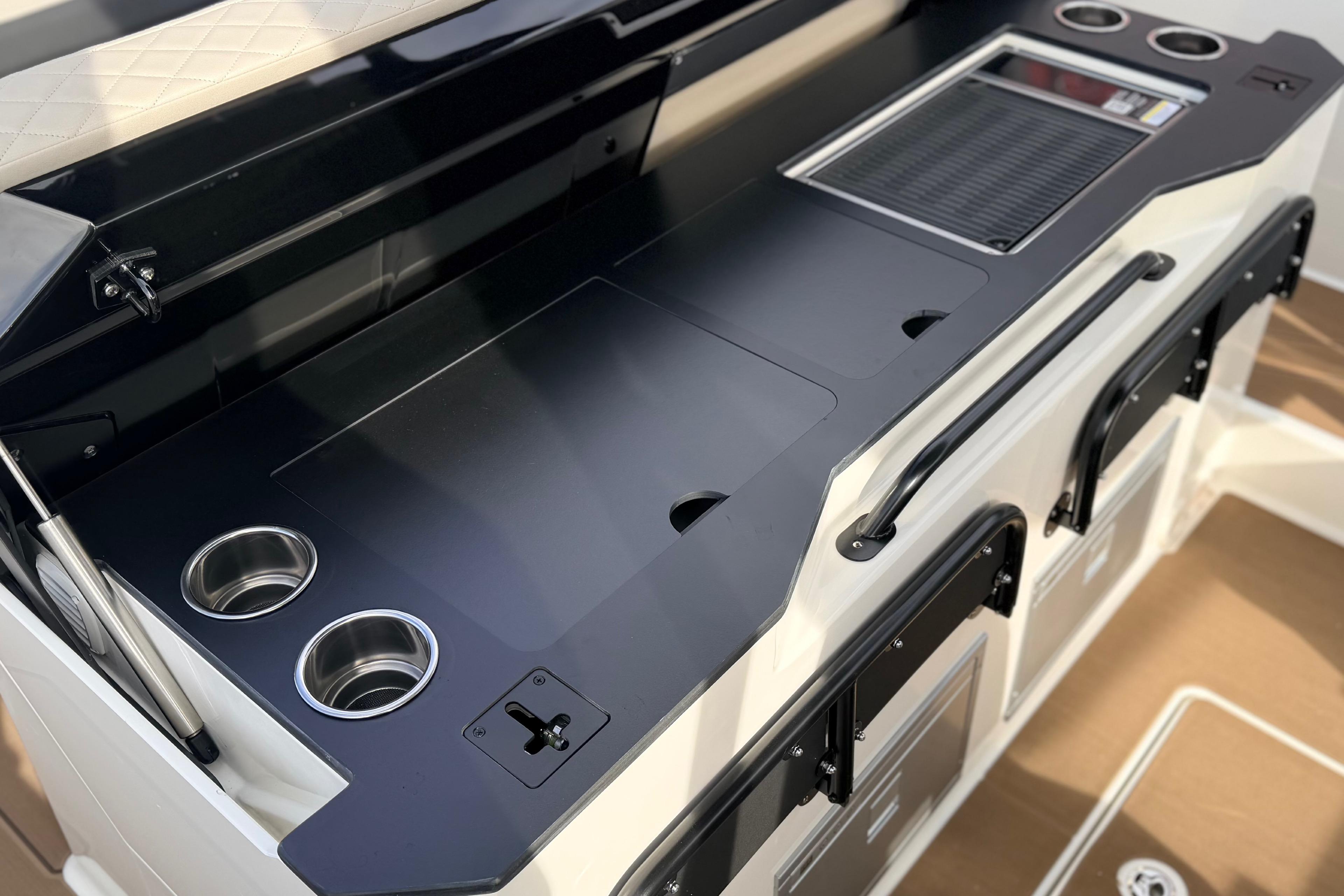 2026 Navan S30 boat interior with sleek black countertop and integrated cup holders.