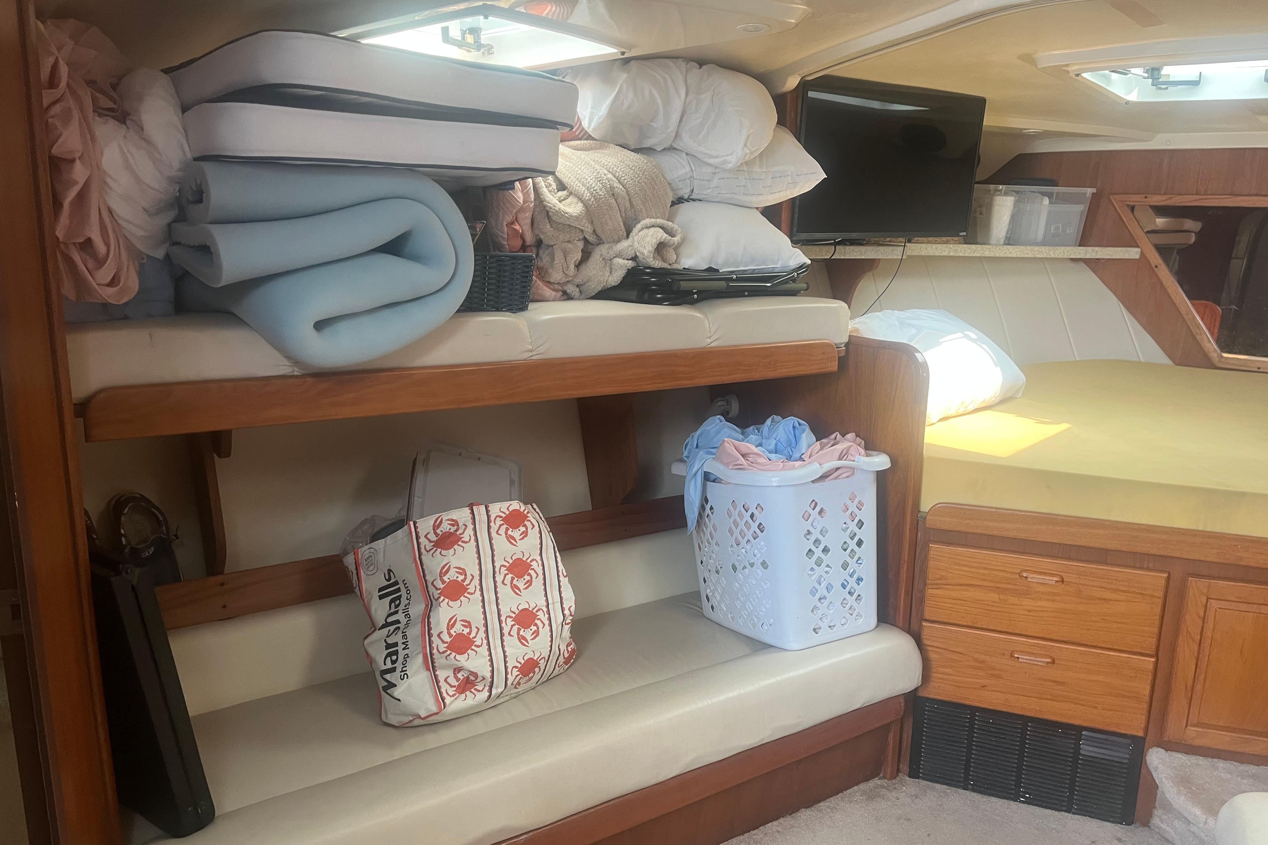 Interior of 1998 Luhrs 36 Open boat with storage, bedding, and TV.
