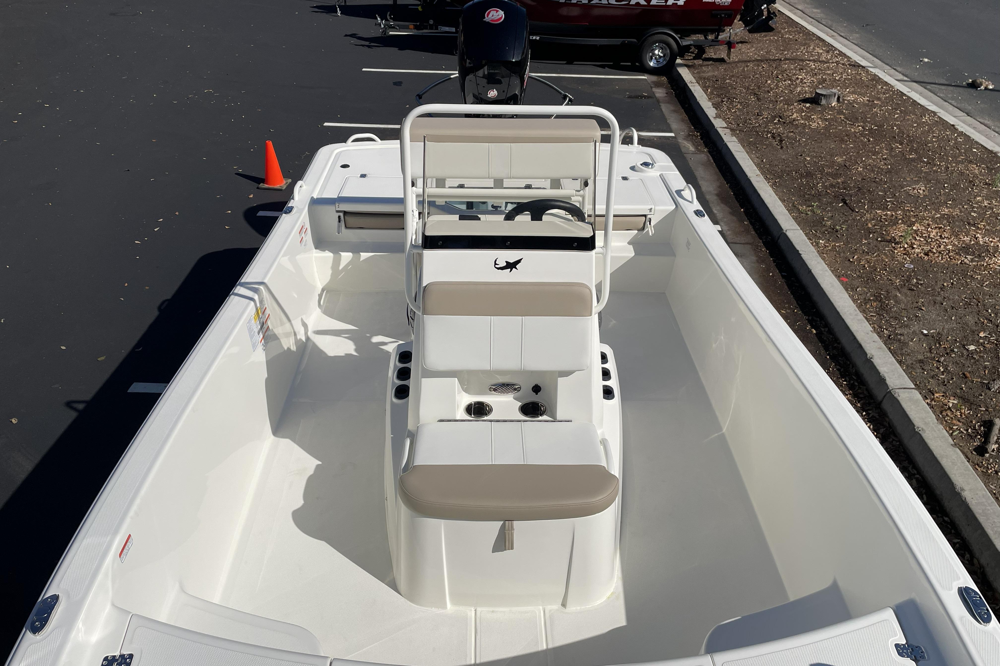 2026 Mako Pro Skiff 19 CC boat with center console, parked on asphalt.