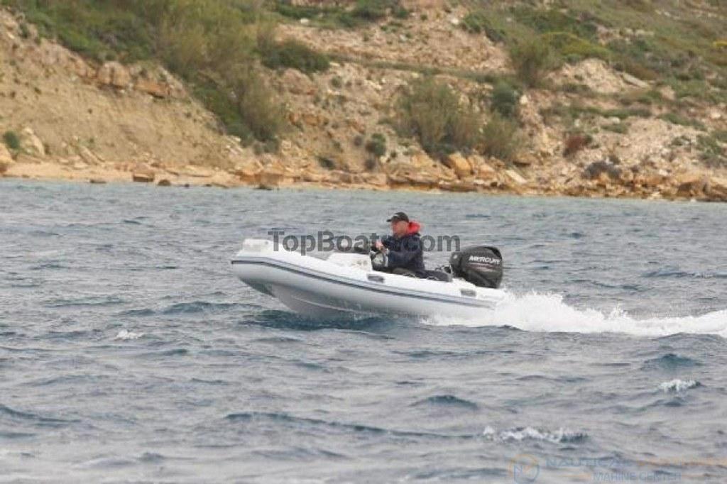 2022 Northstar Axs 3.1 boat cruising on water near rocky shoreline.