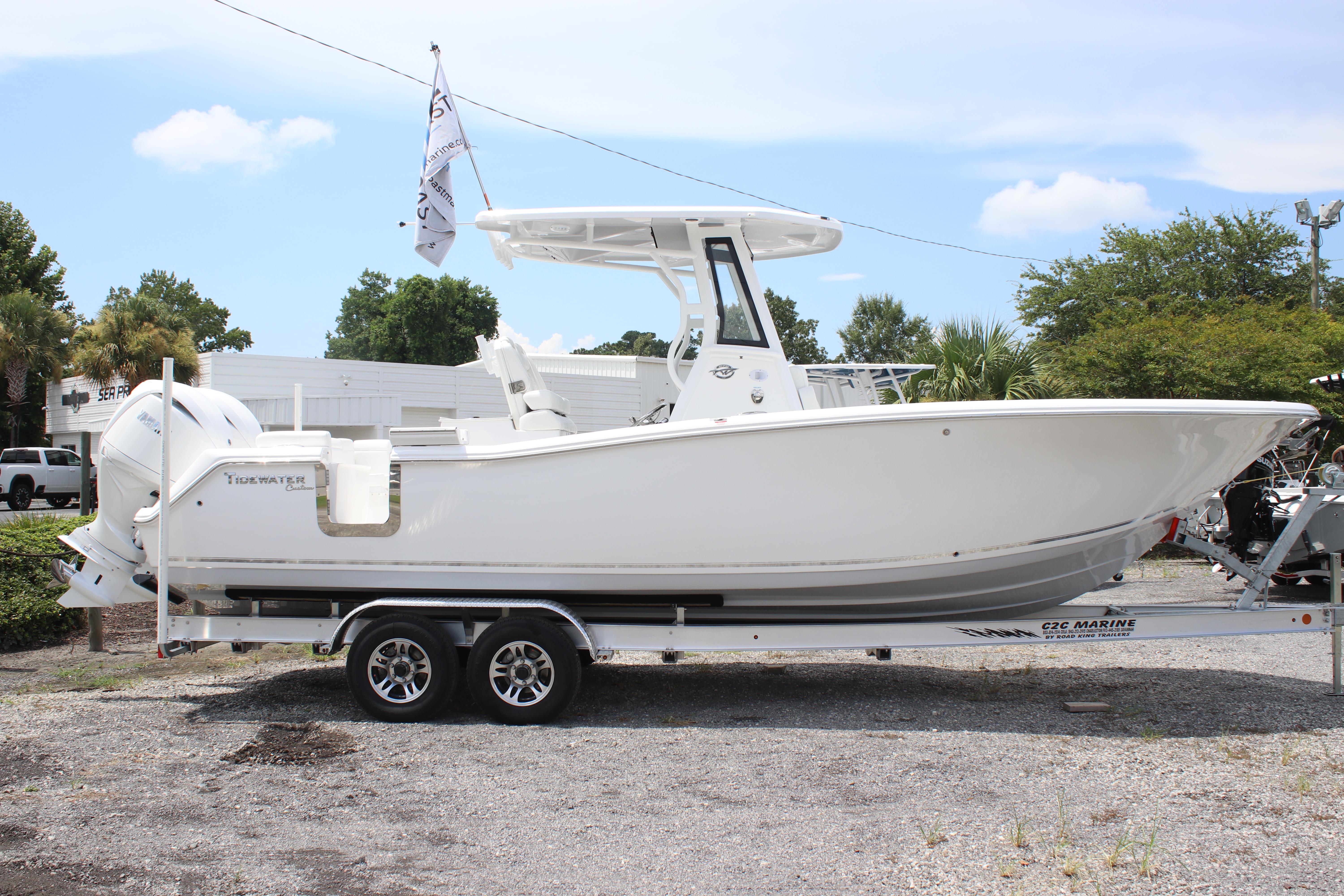 2026 Tidewater 272 LXF boat on trailer, displayed outdoors under clear sky.