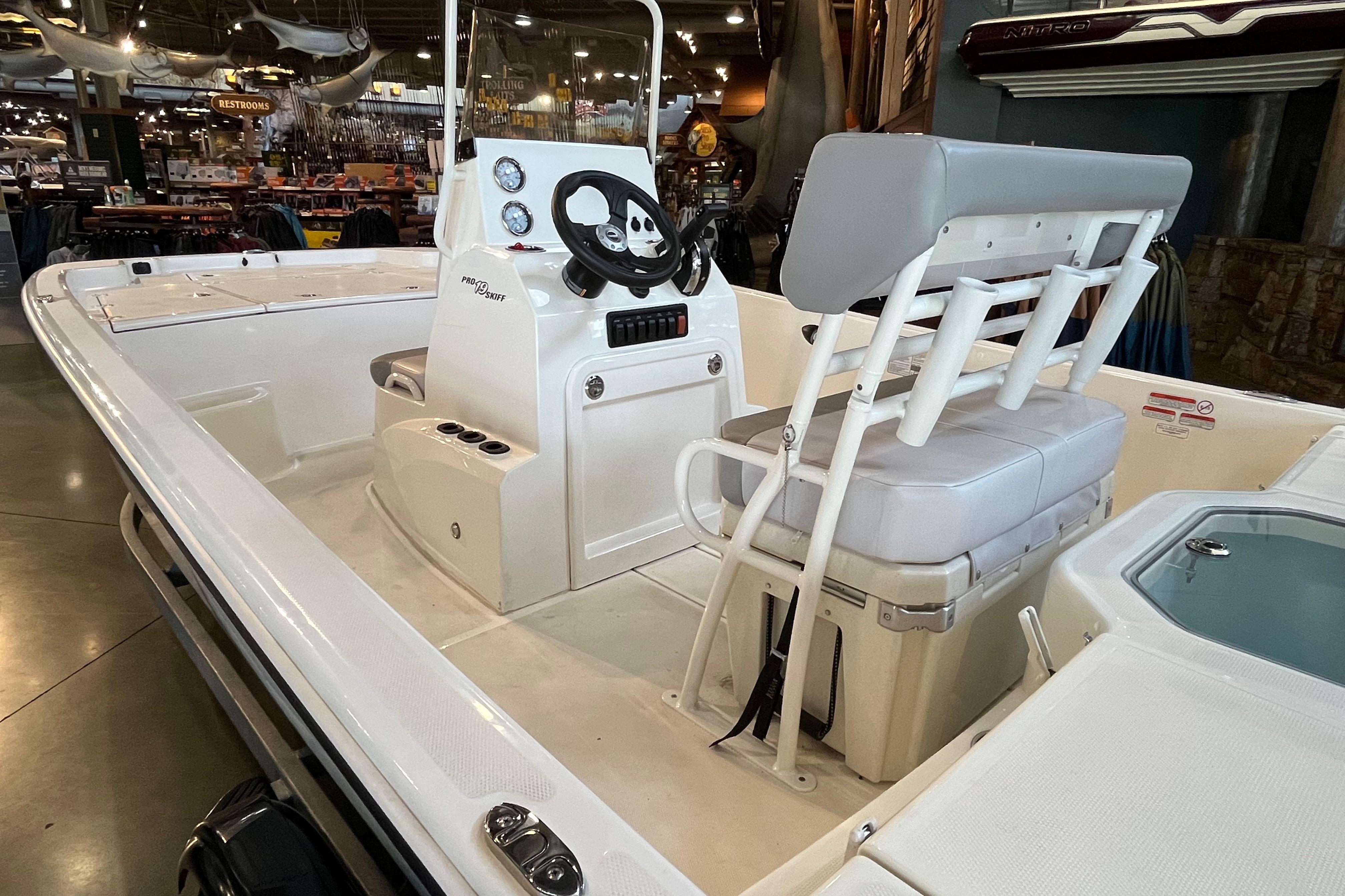 2024 Mako Pro Skiff 19 CC boat interior with steering console and seating.