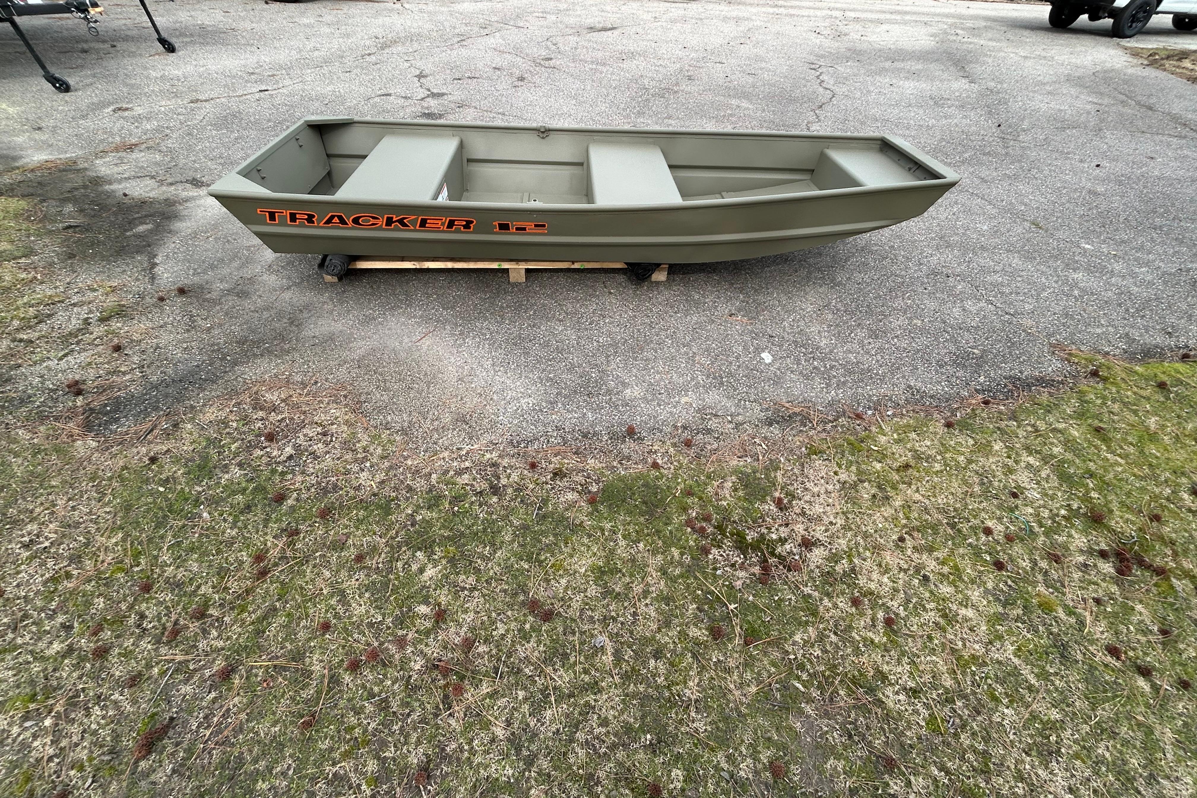 2026 Tracker Grizzly 12 Jon boat on pavement, showcasing sturdy design and compact size.