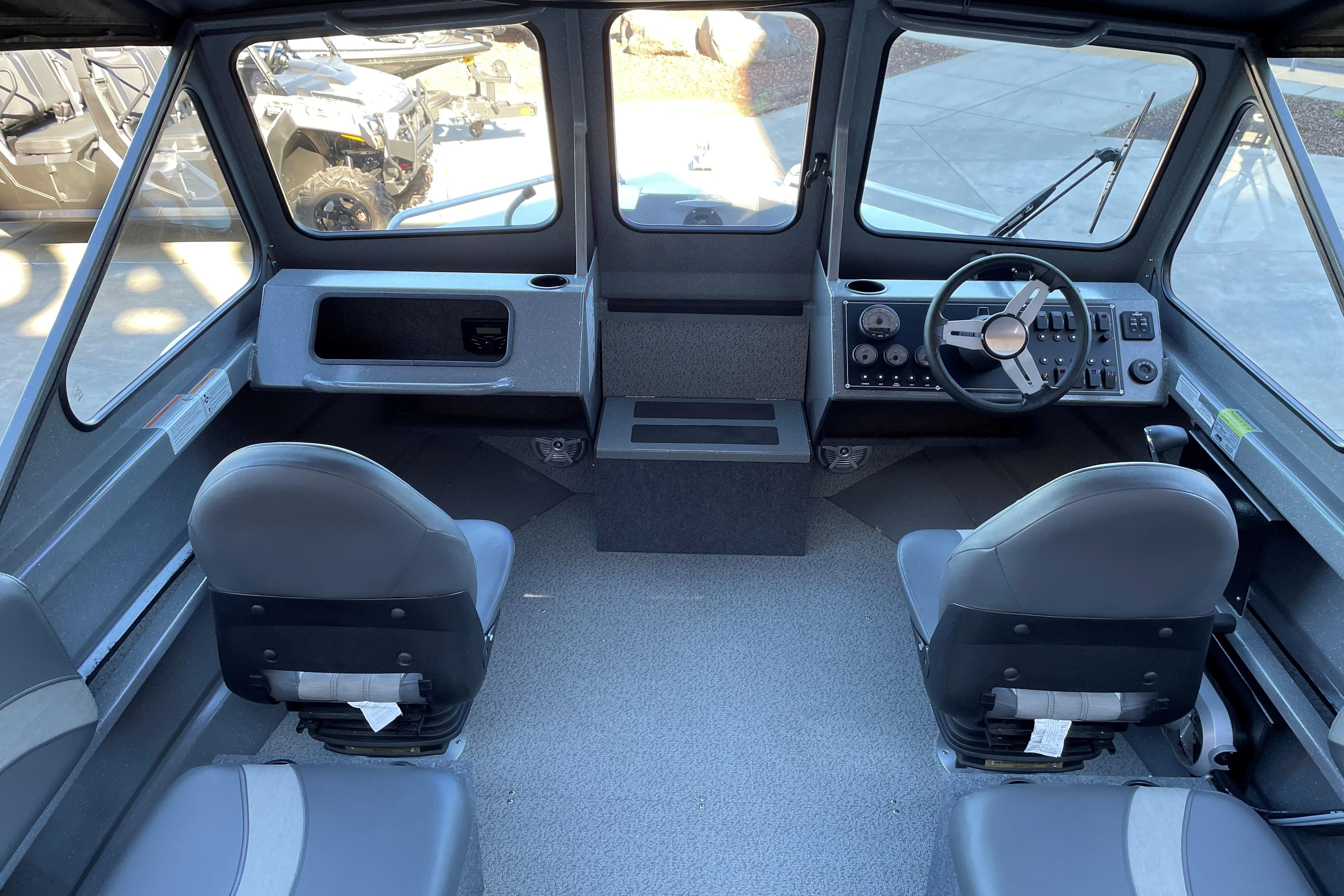 Interior of 2025 Spartan 200 Astoria boat with dual seats and control panel.