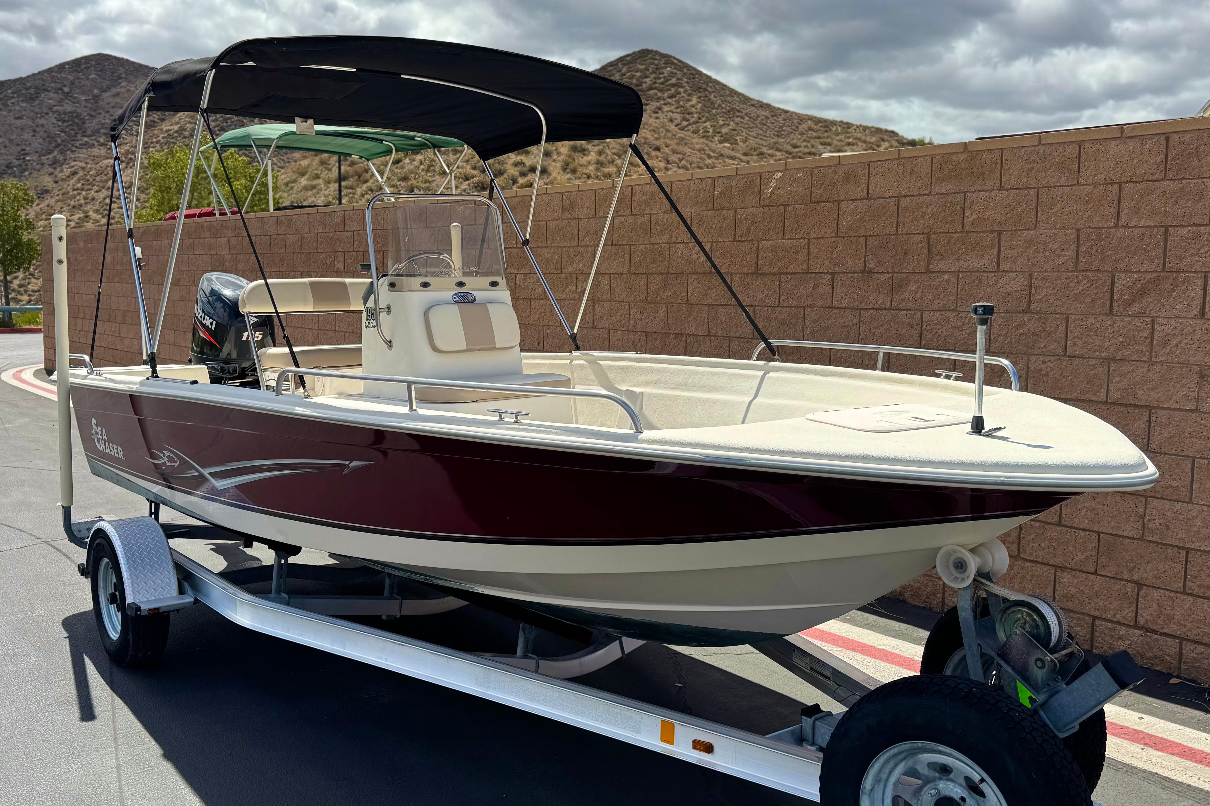 2013 Carolina Skiff Sea Chaser 1950 RG boat on trailer, parked outdoors.