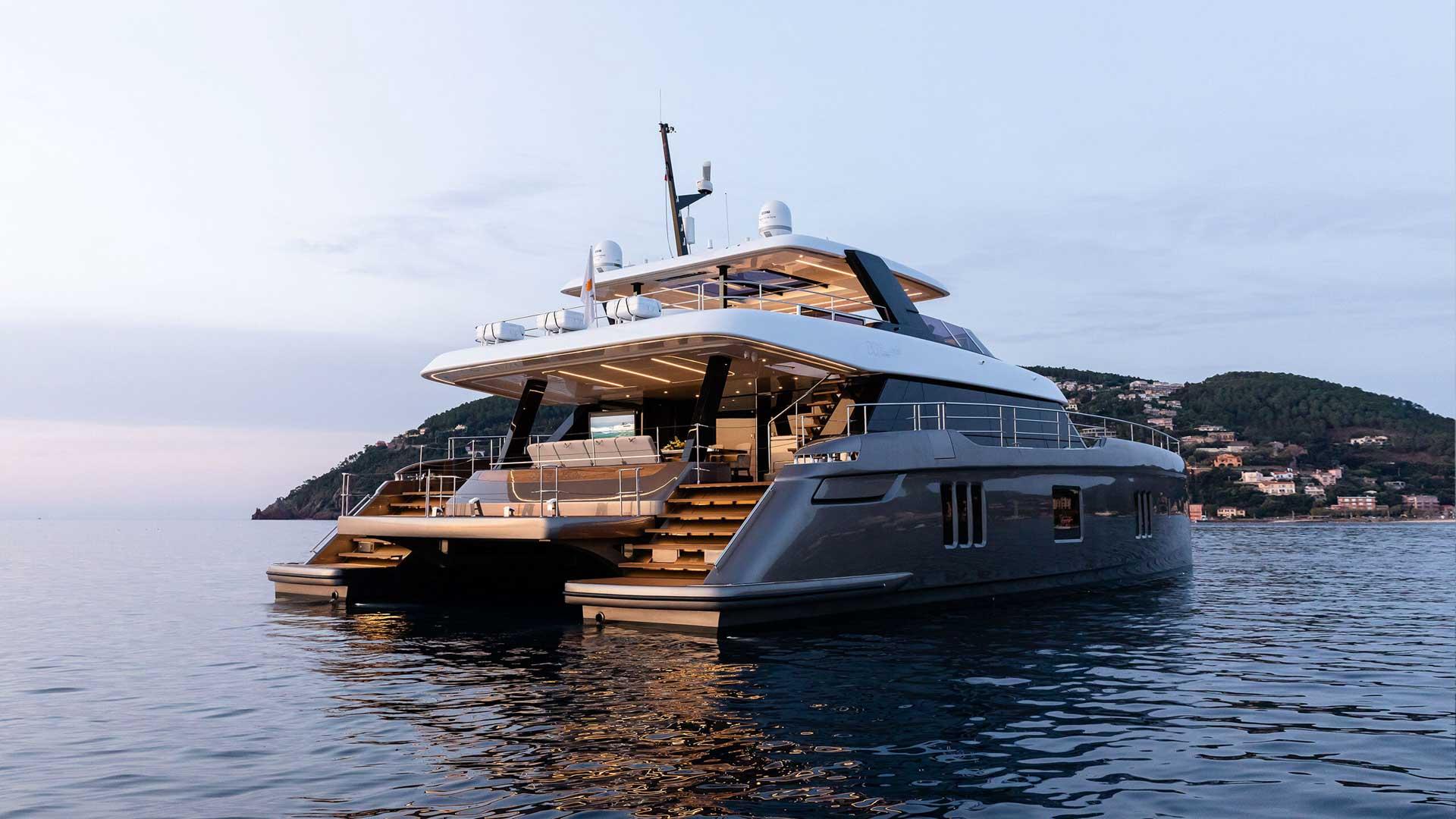 2026 Sunreef 80 Sunreef Power yacht on calm water at sunset.