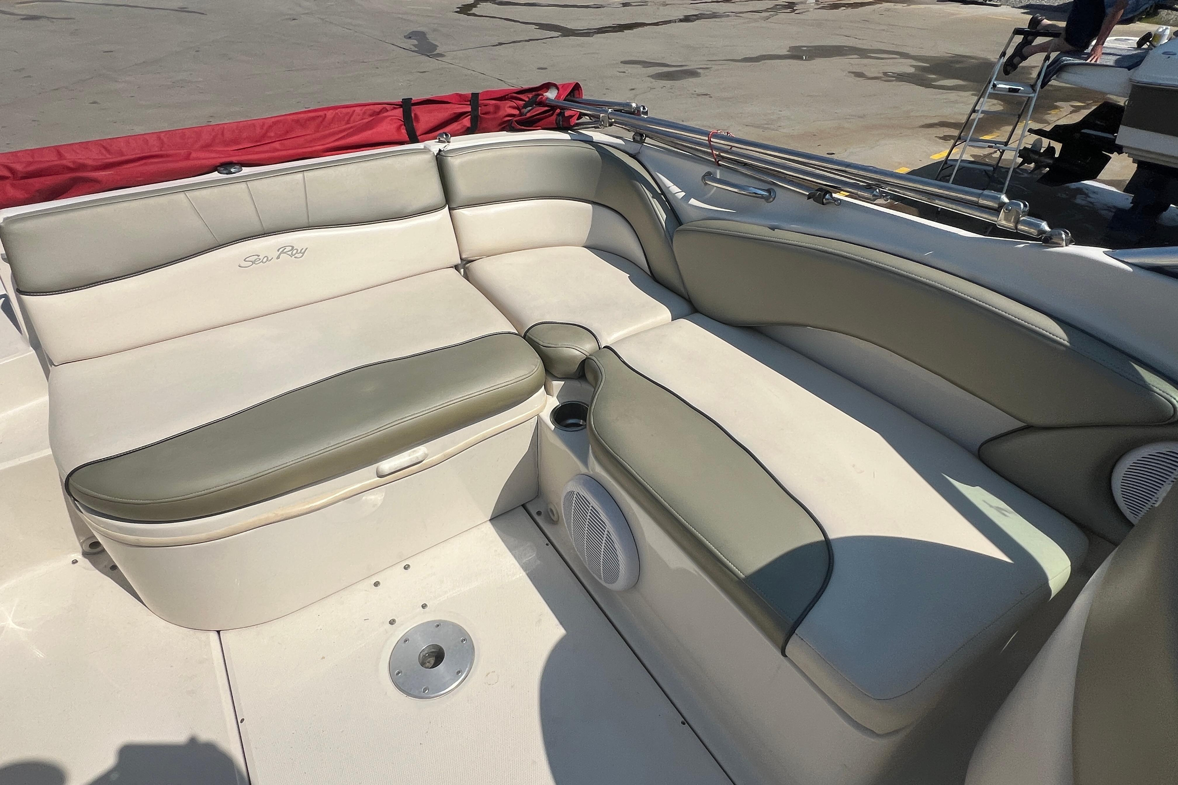 2005 Sea Ray 240 Sundeck boat interior with cushioned seating and cup holders.
