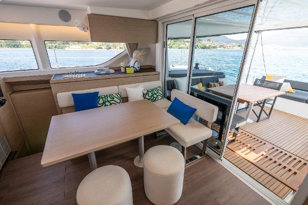 Luxurious interior of 2025 Lagoon 43 yacht with modern dining area and scenic water views.