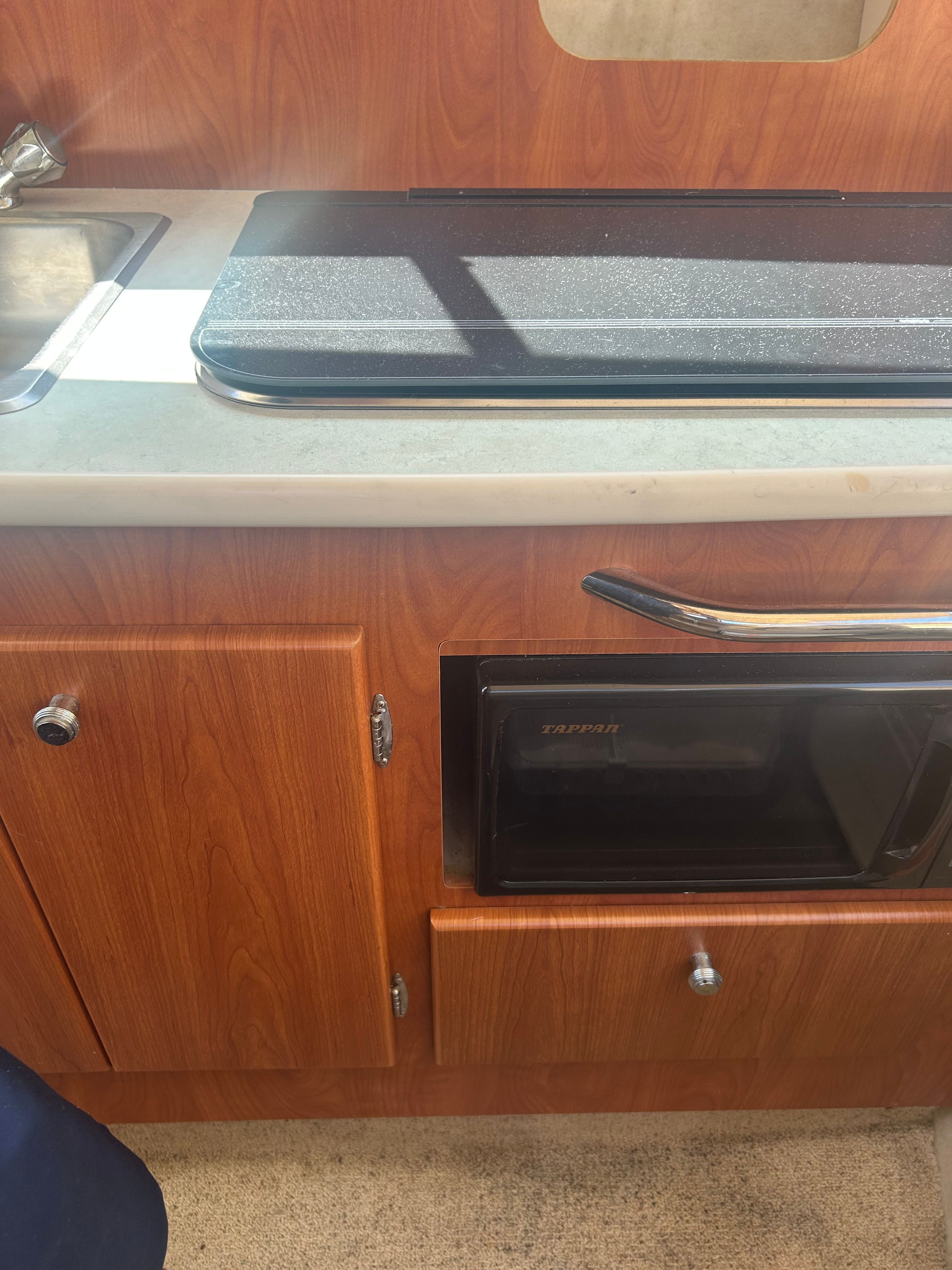 Kitchen area in a 2005 Bayliner Classic 242 boat.
