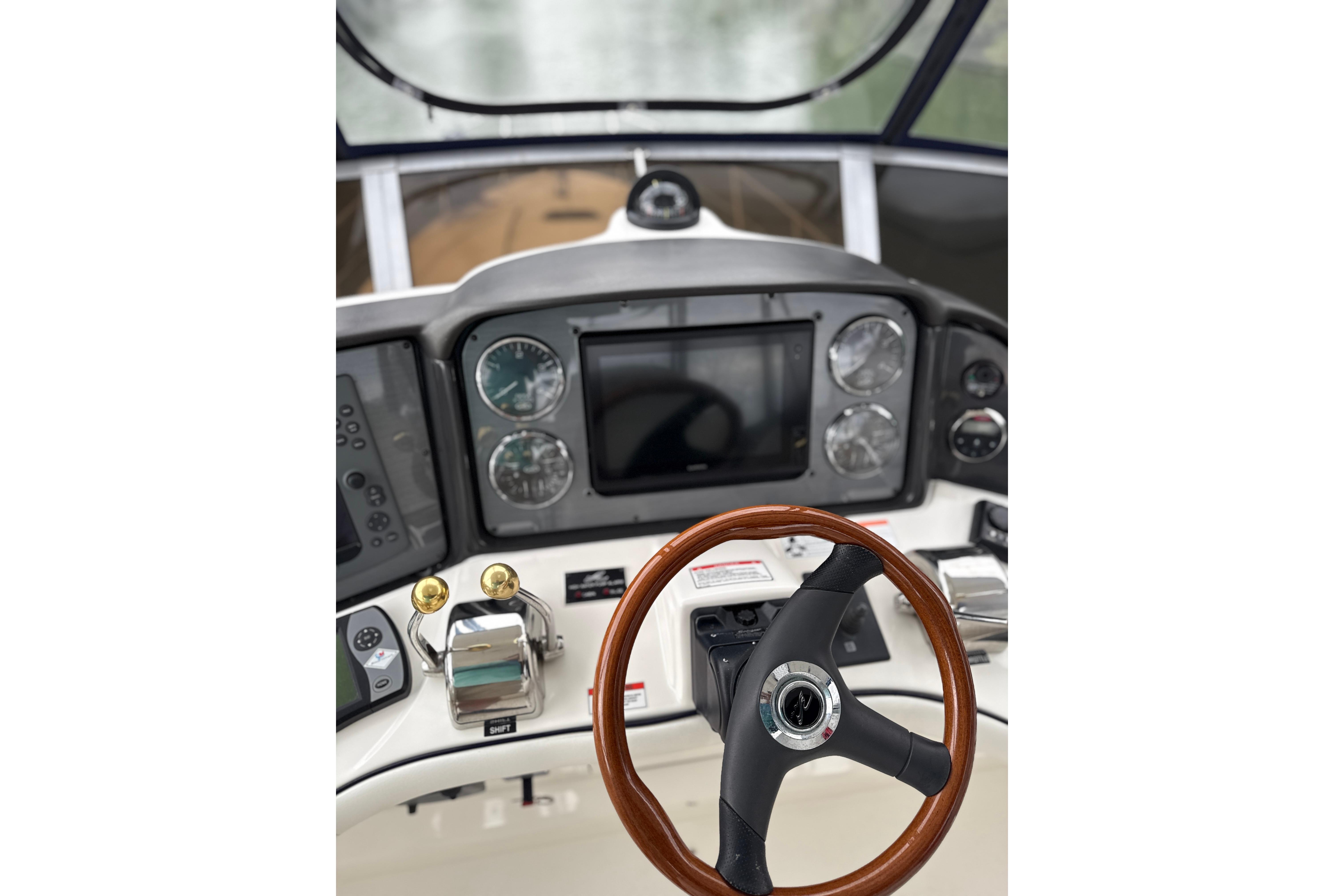 2007 Sea Ray 44 Sedan Bridge helm with steering wheel and navigation controls.