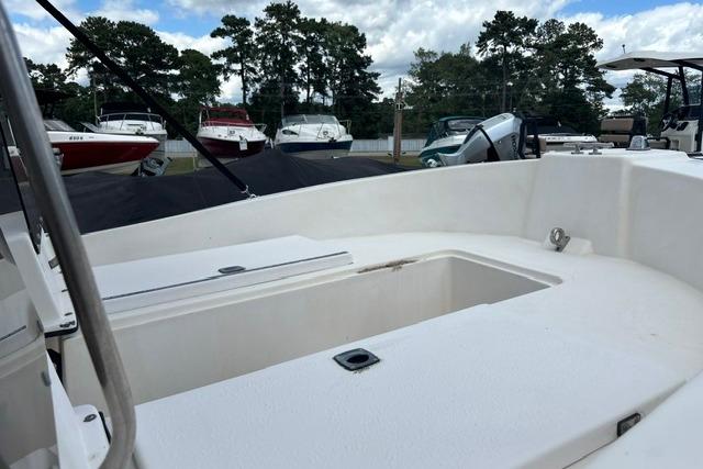 1989 Henry O 150 Dual Console boat interior with open storage compartment.