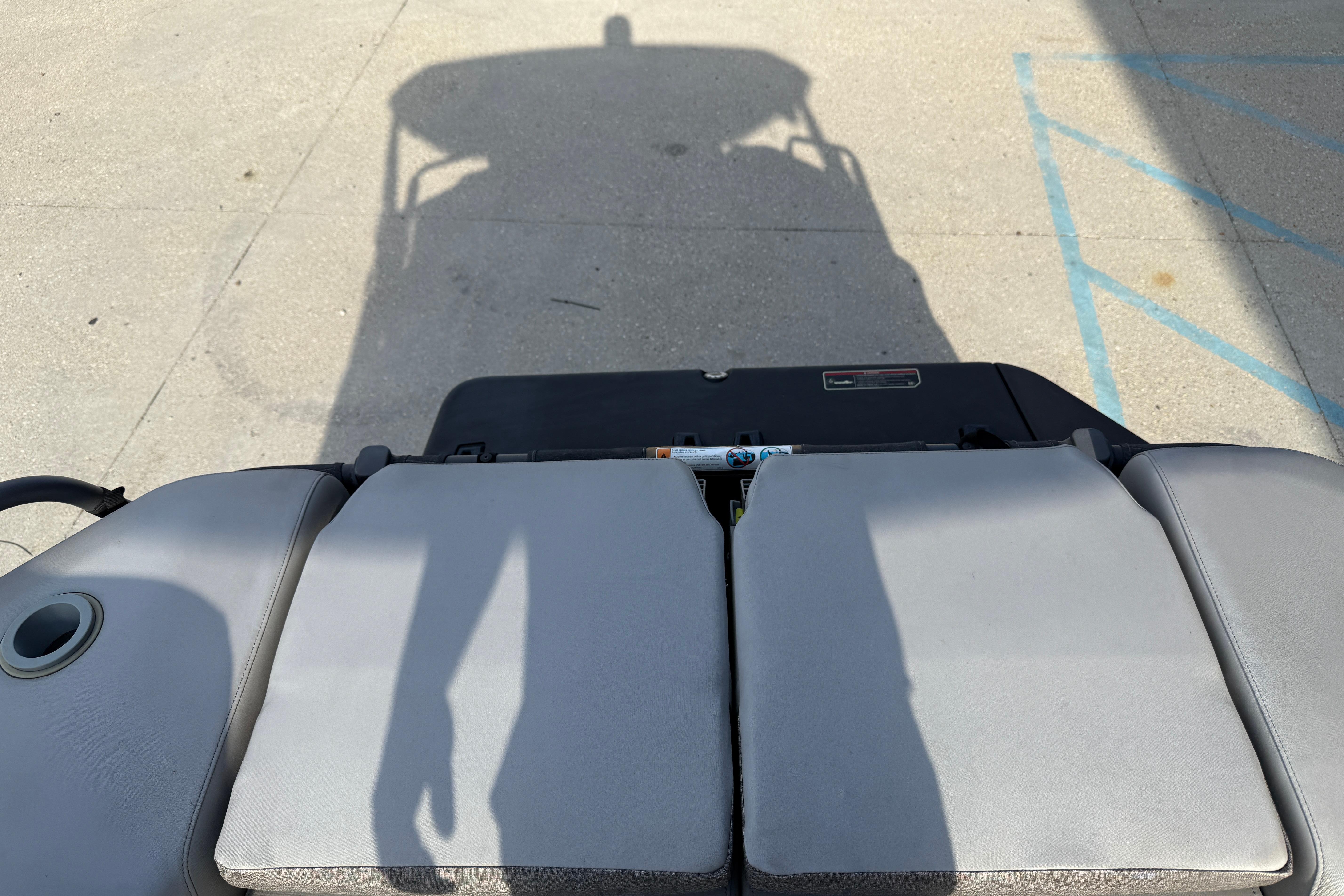 2023 Sea-Doo Switch Sport 18 with shadow on deck, showcasing seating and design.