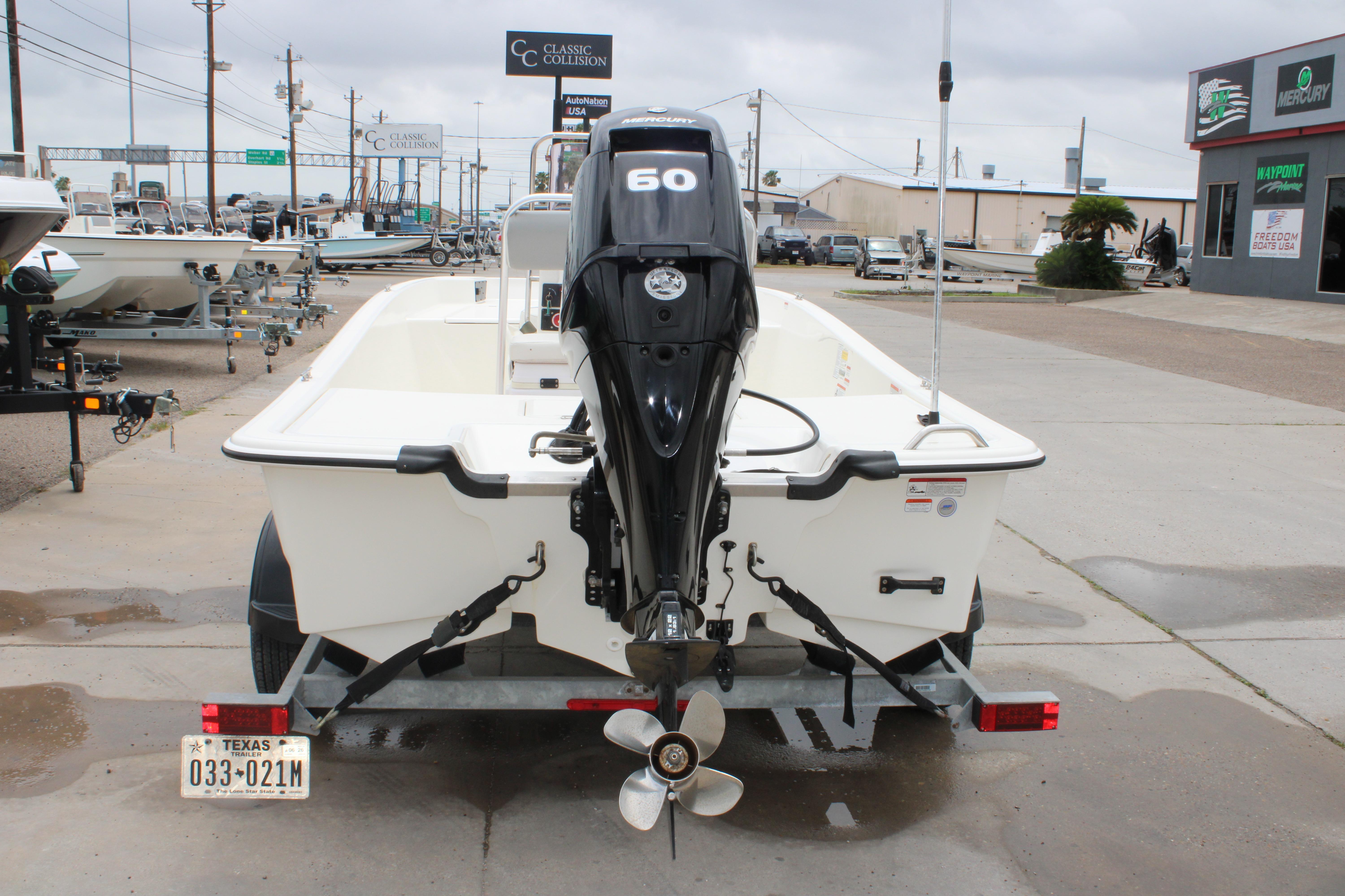 2021 Mako Pro Skiff 17 CC boat with outboard motor on a trailer.