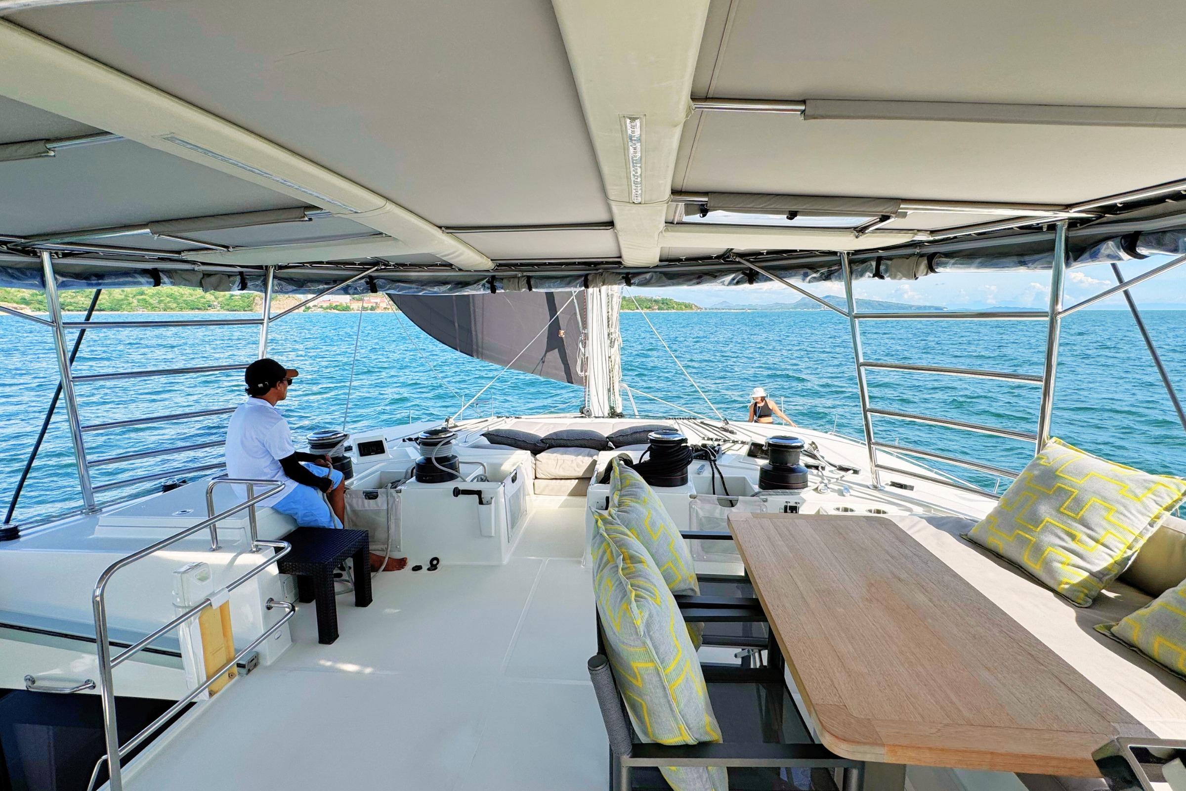 Luxurious Lagoon 620 yacht interior with seating, table, and ocean view, 2015 model.