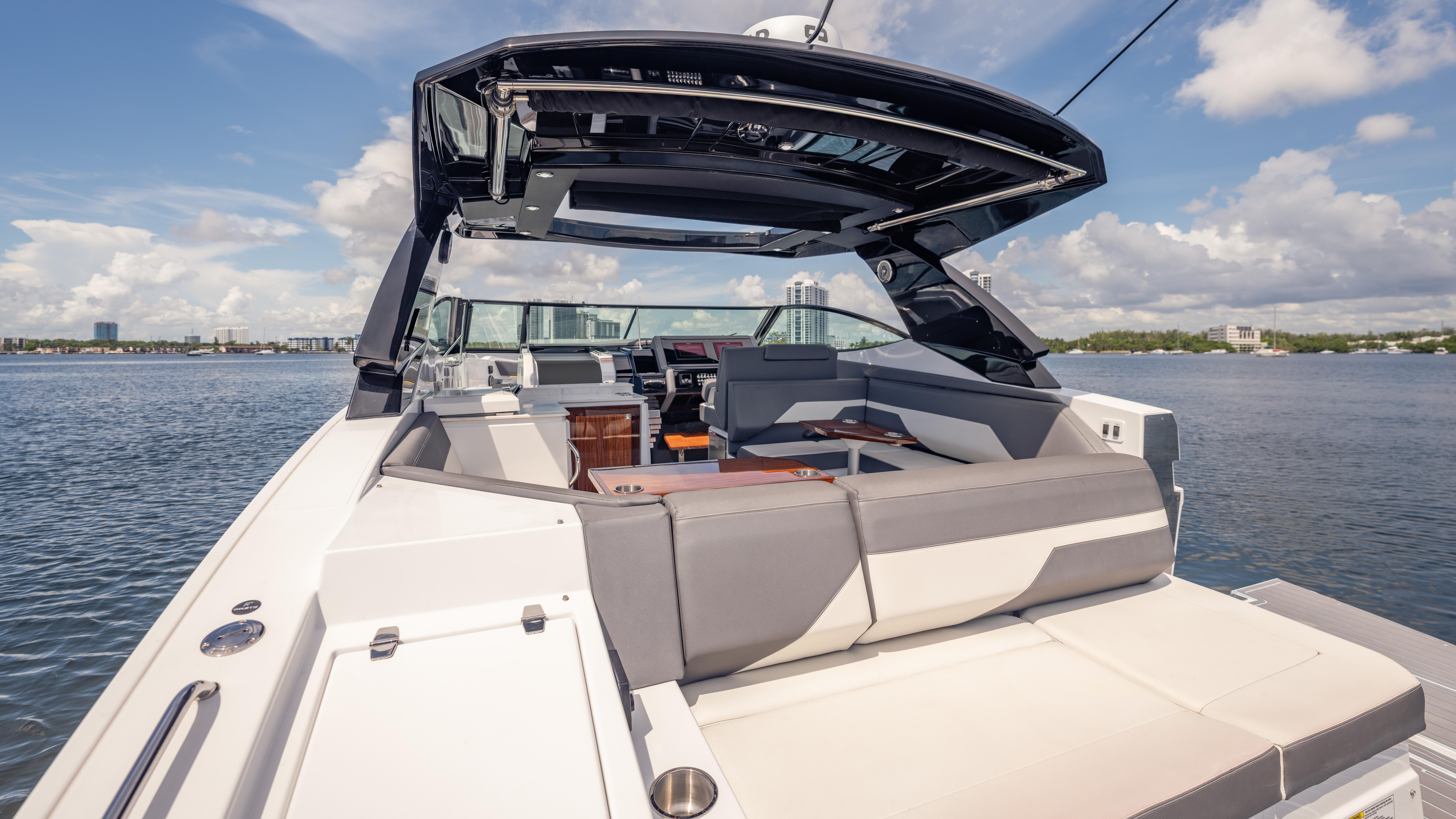 2021 Cruisers Yachts 38 GLS luxury boat with spacious seating on a sunny day.