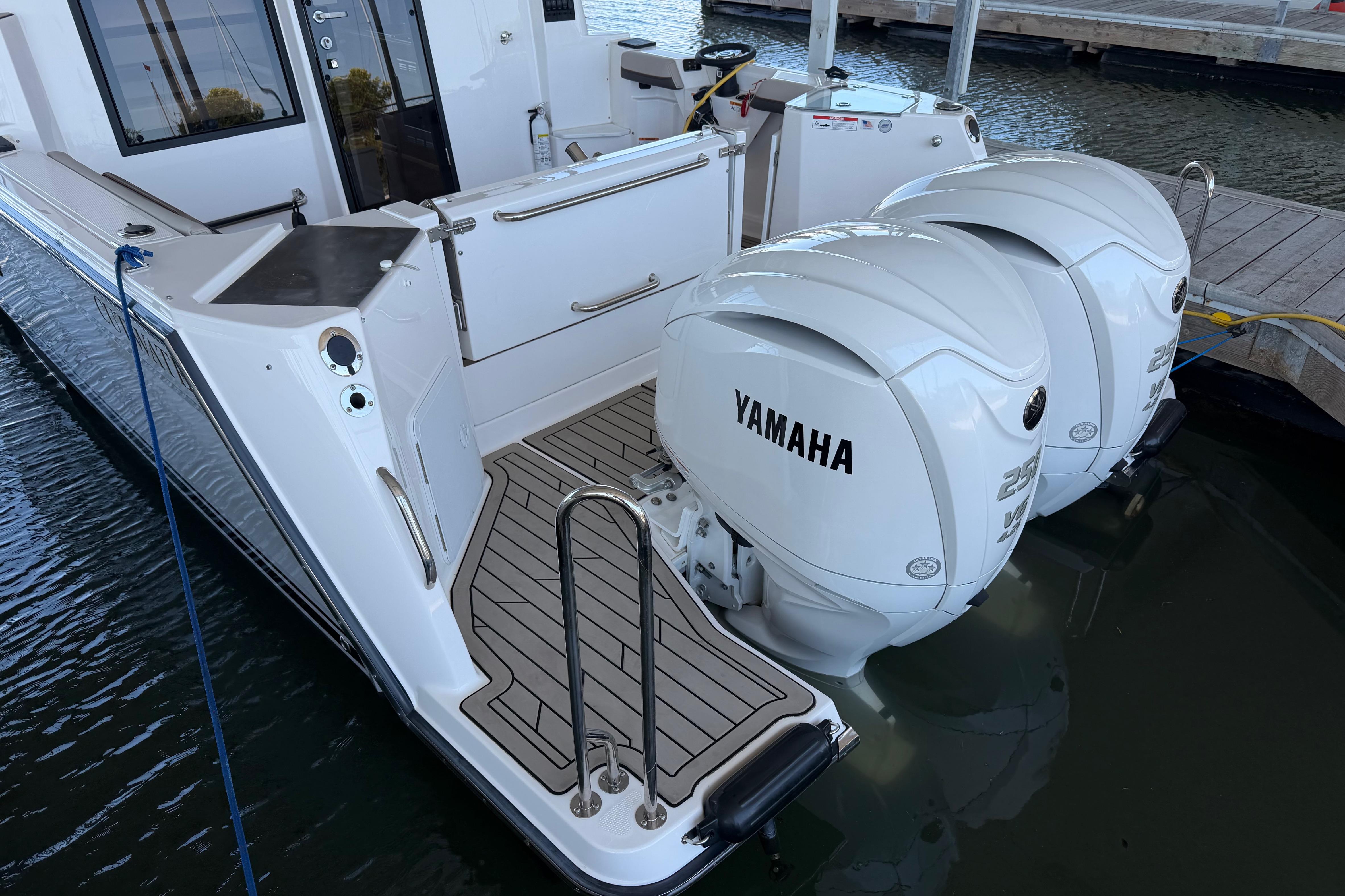 2023 Cutwater C-288 Coupe with twin Yamaha outboard engines docked at marina.
