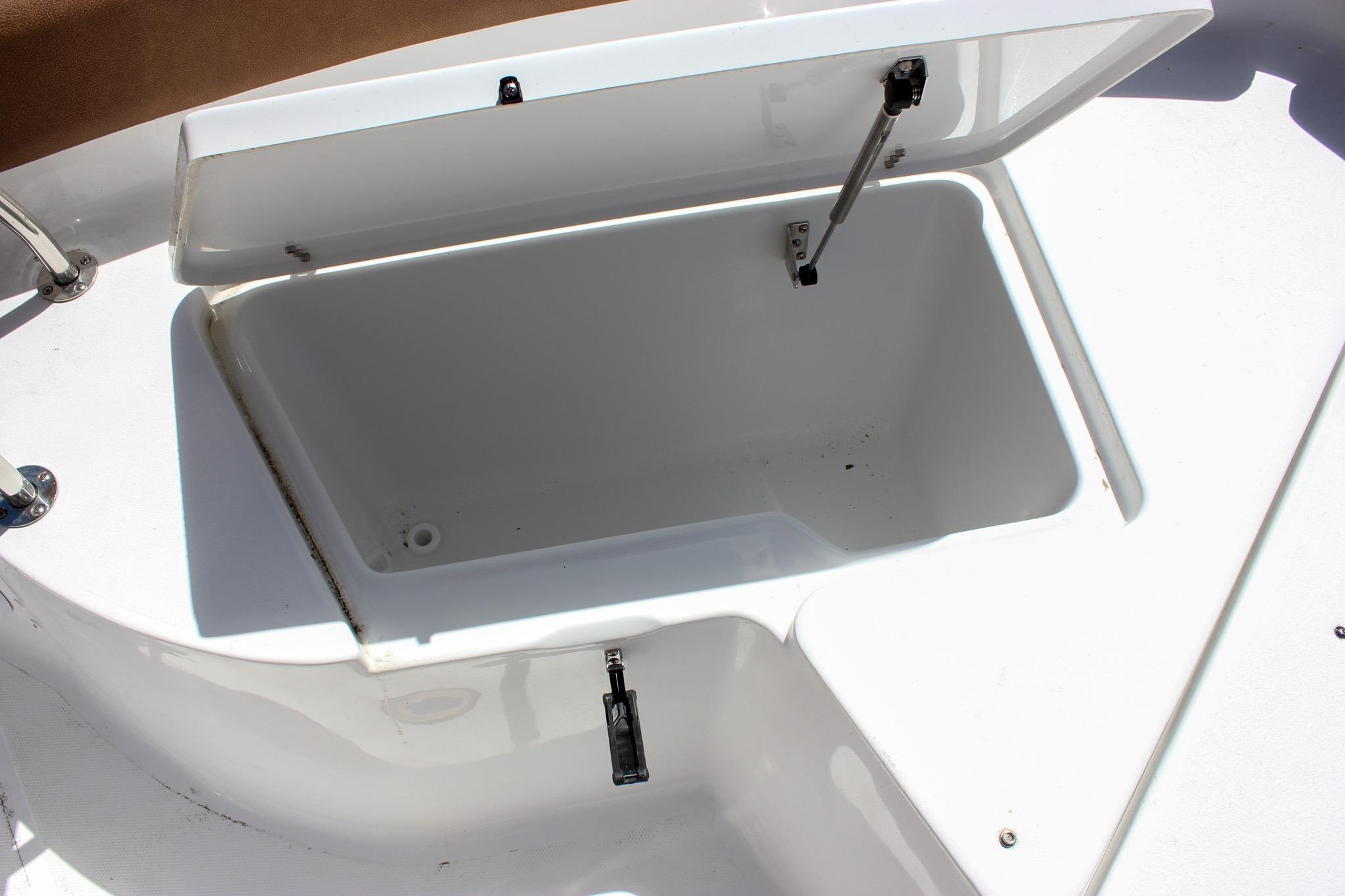 Open storage compartment on a 2027 Sea Hunt Ultra 234 boat.