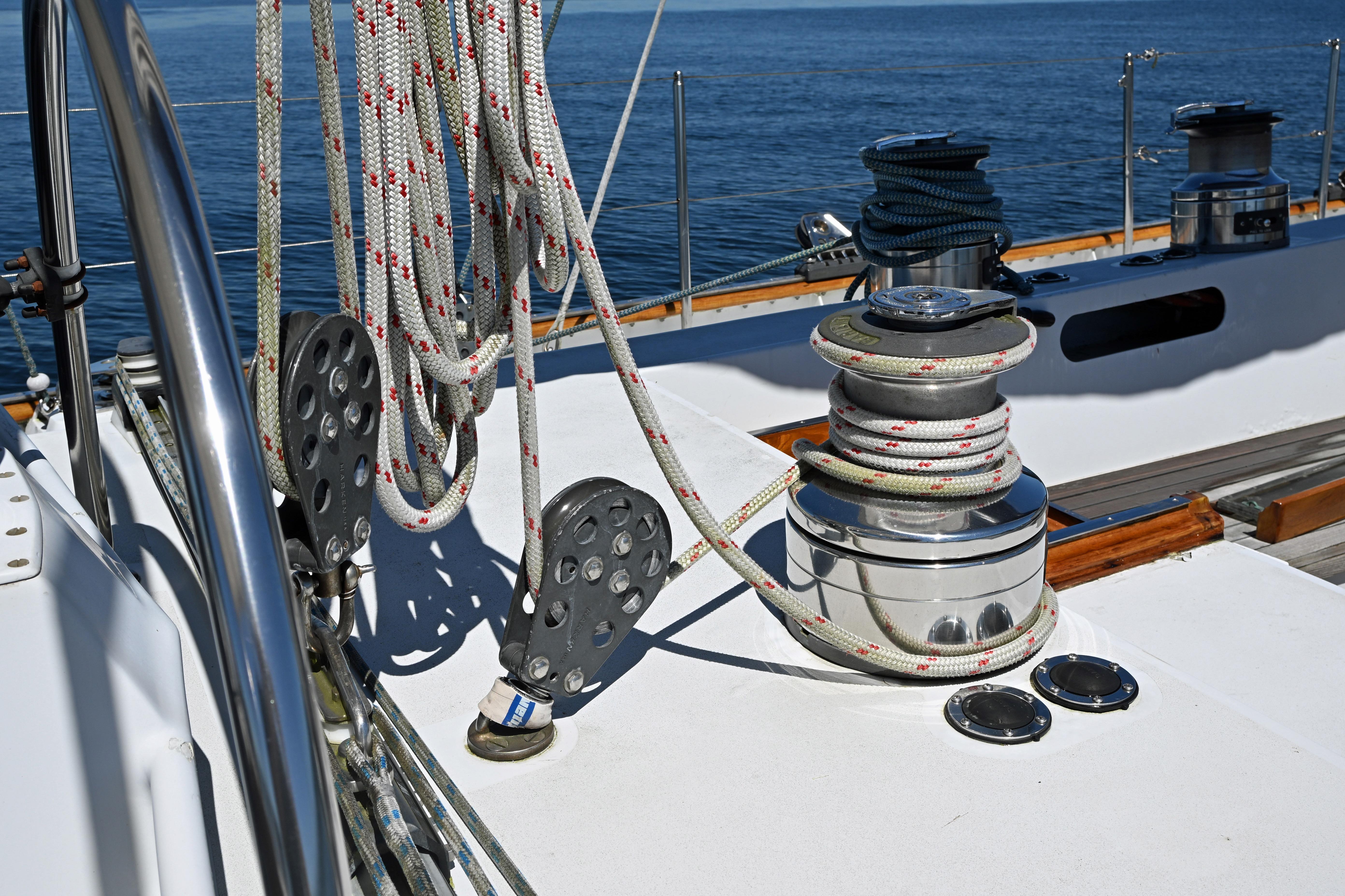 Deck of 1968 Abeking & Rasmussen Tripp 74 yacht with winch and ropes.