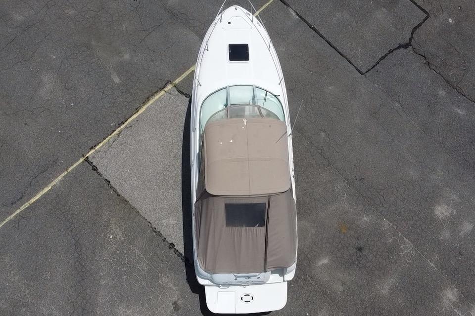 Overhead view of 2001 Sea Ray 245 Weekender boat on pavement.