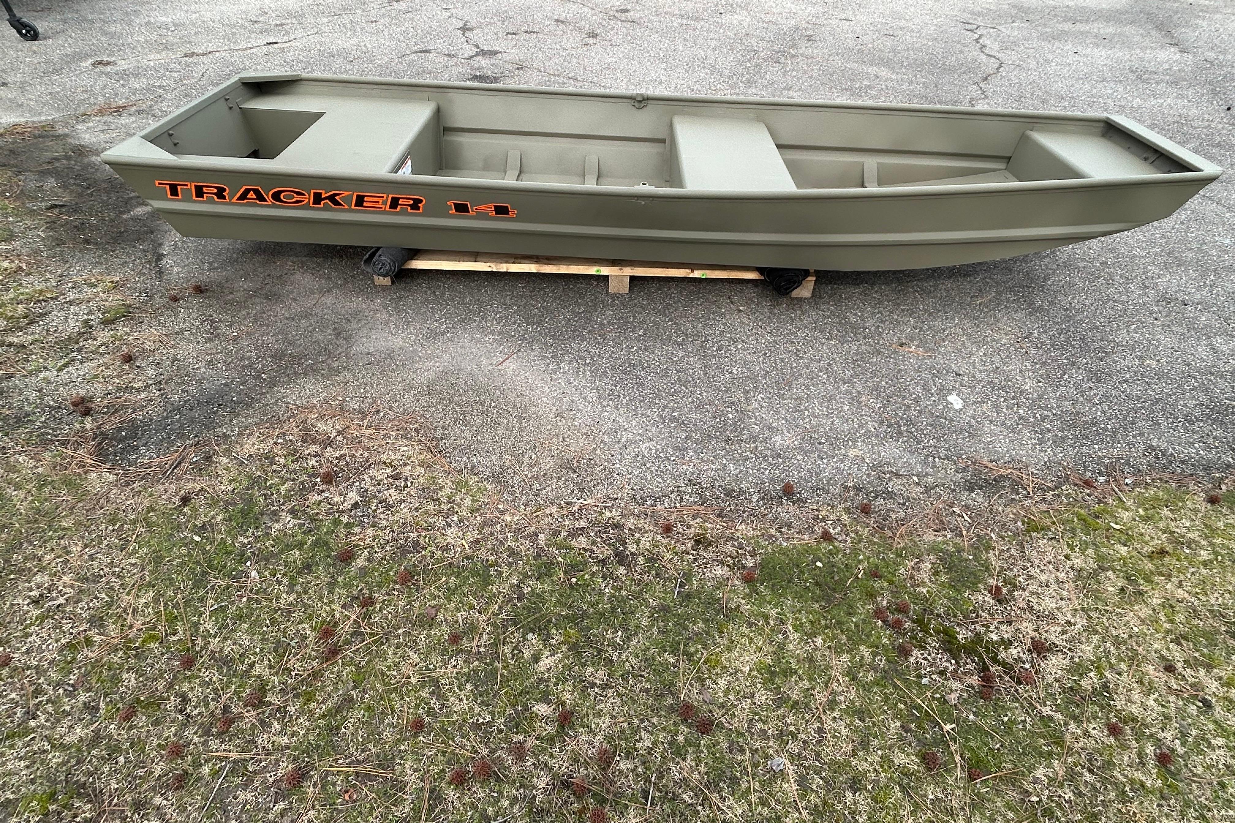 2026 Tracker Grizzly 14 Jon boat on pavement, showcasing its sturdy design and spacious interior.
