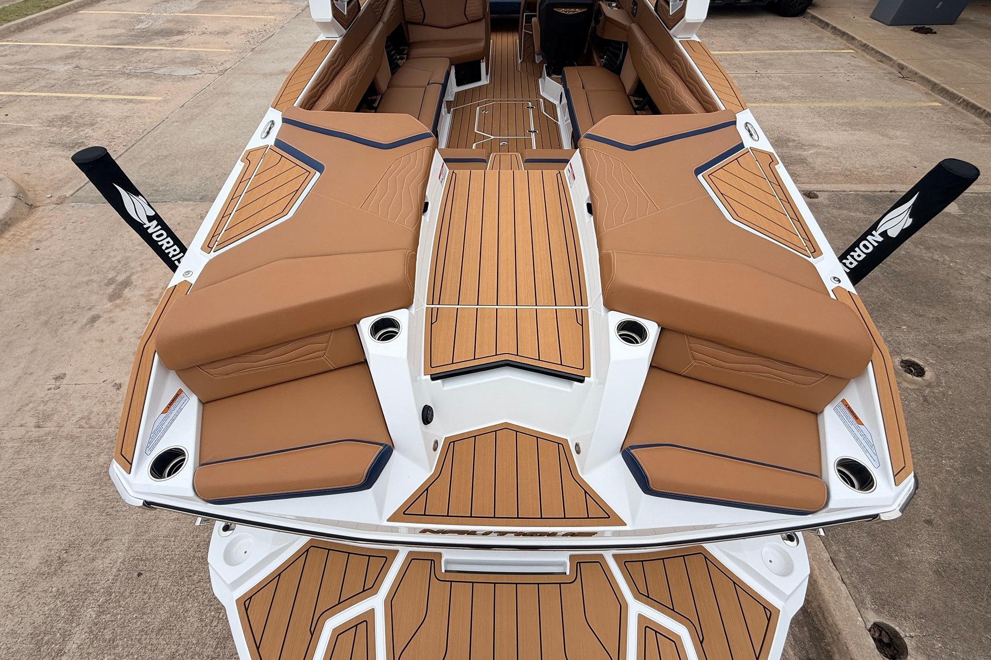 2026 Nautique Super Air Nautique G25 boat with tan seating and teak flooring.