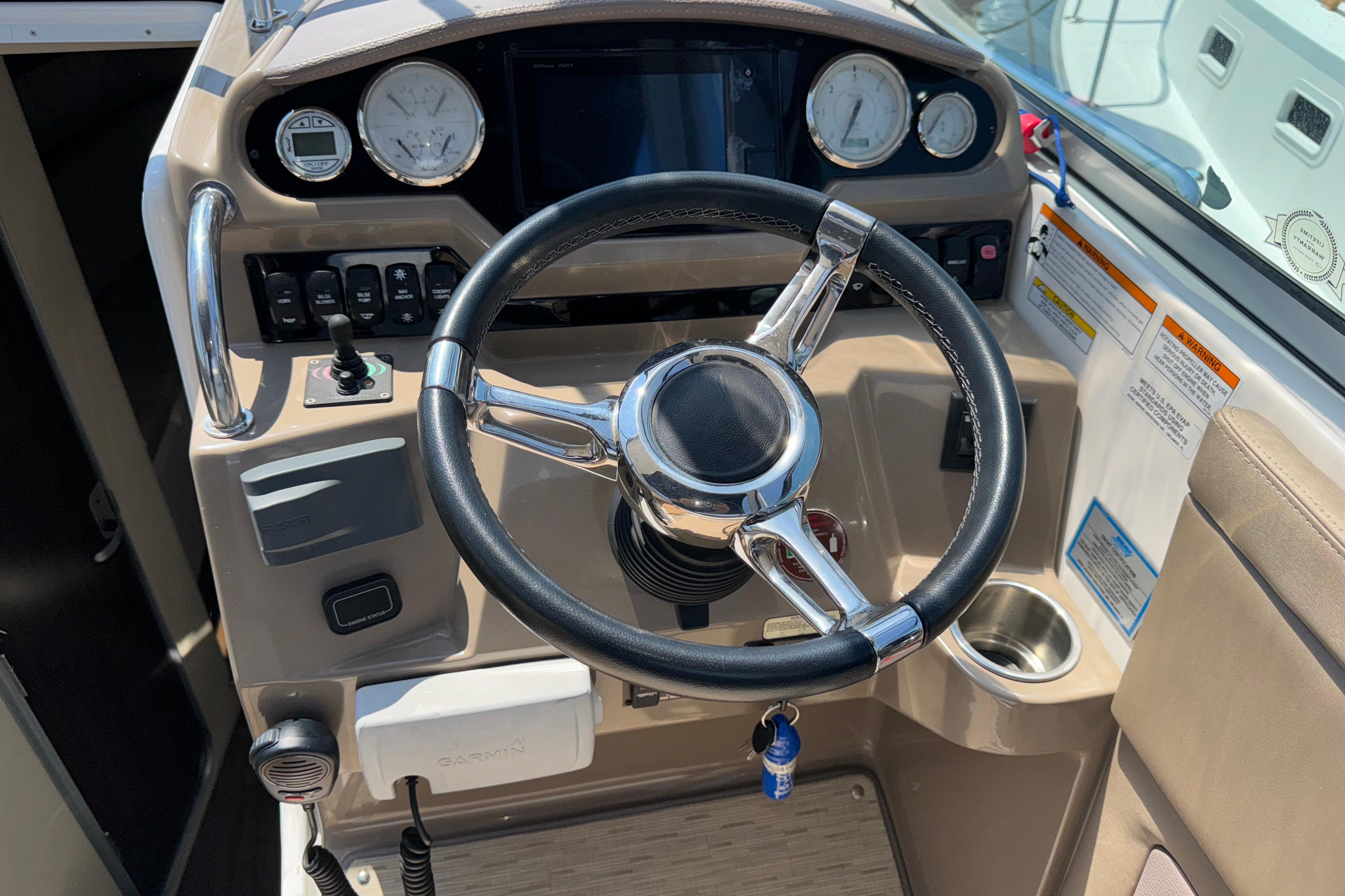 Steering wheel and dashboard of a 2017 Regal 28 Express boat cockpit.