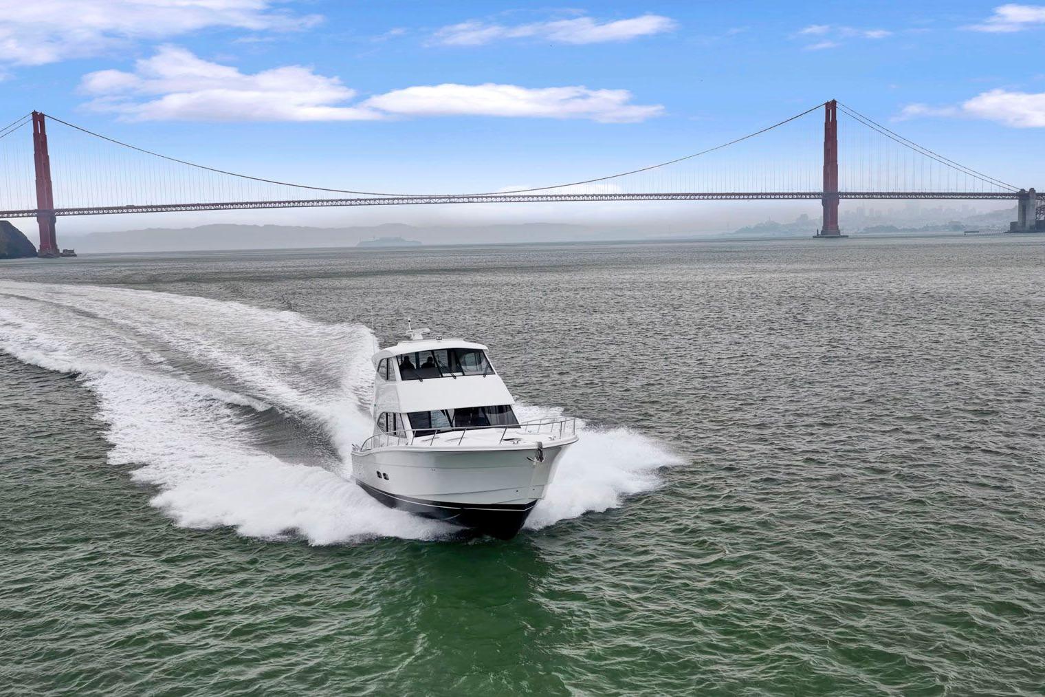 2014 Maritimo M50 yacht cruising near Golden Gate Bridge under blue sky.