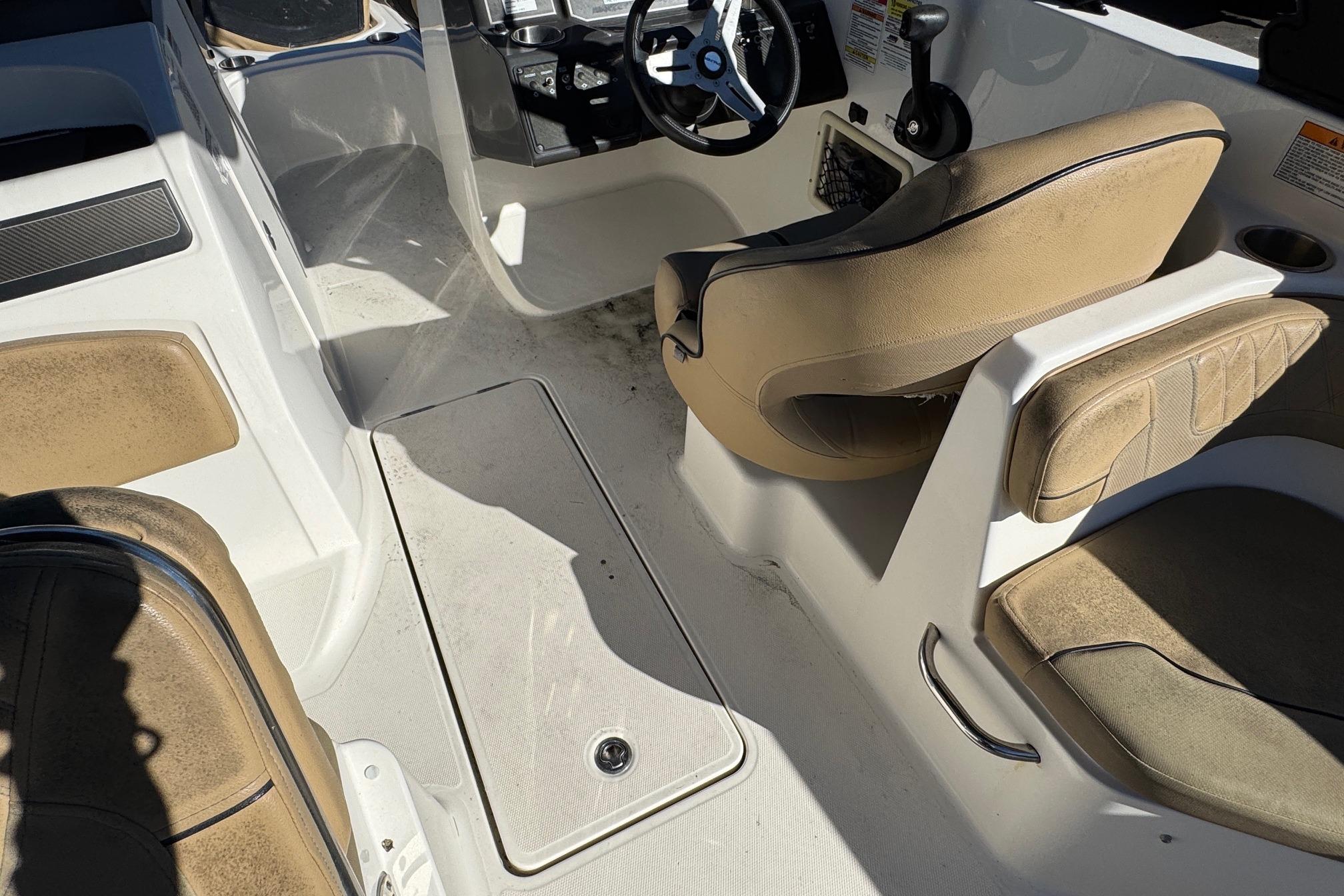 2022 Bayliner VR6 Bowrider OB interior with beige seating and steering console.
