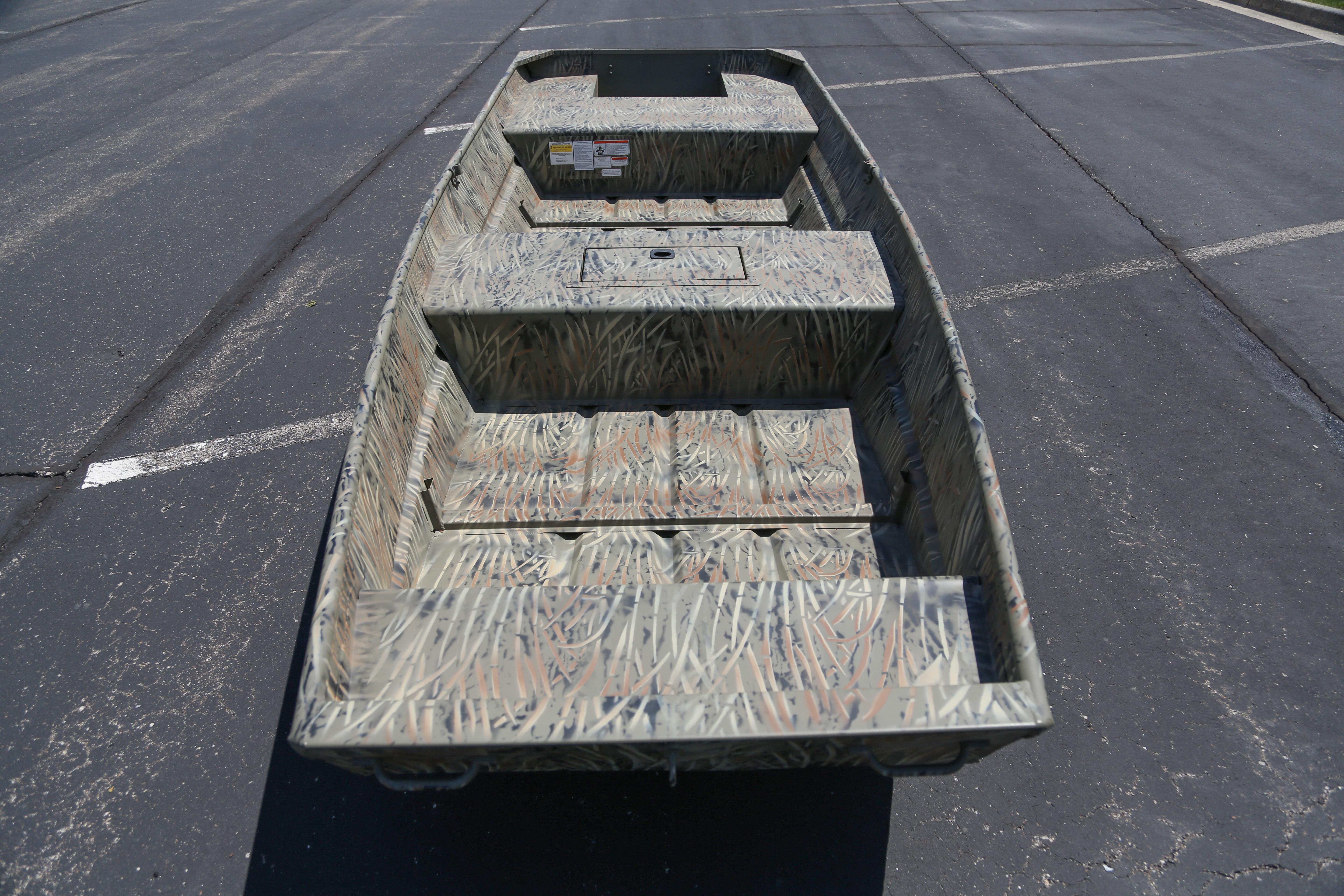 2026 Tracker Grizzly 15 Jon boat with camouflage design on asphalt surface.