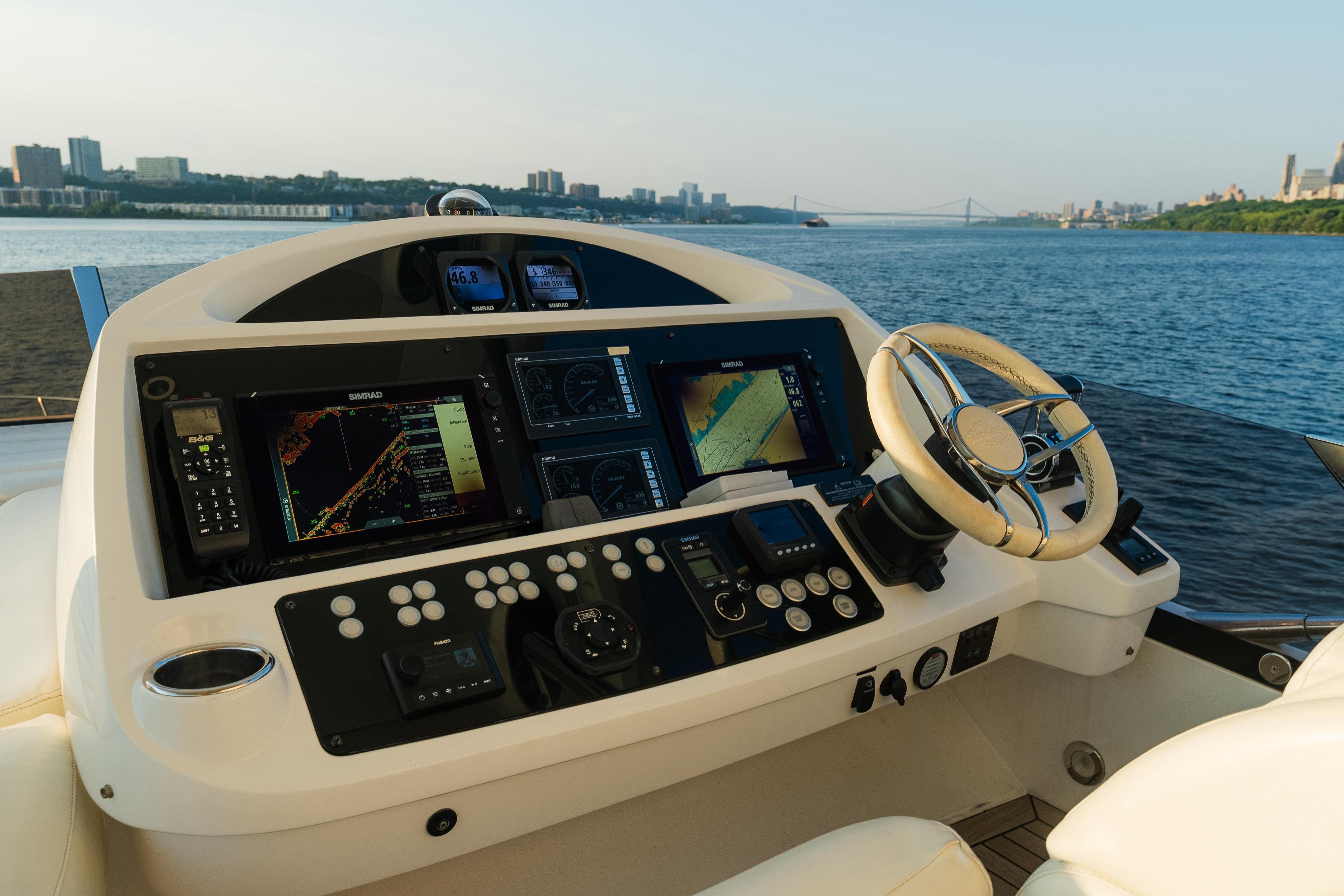 Cockpit of 2016 Sunseeker Manhattan 65 yacht with navigation equipment and scenic water view.