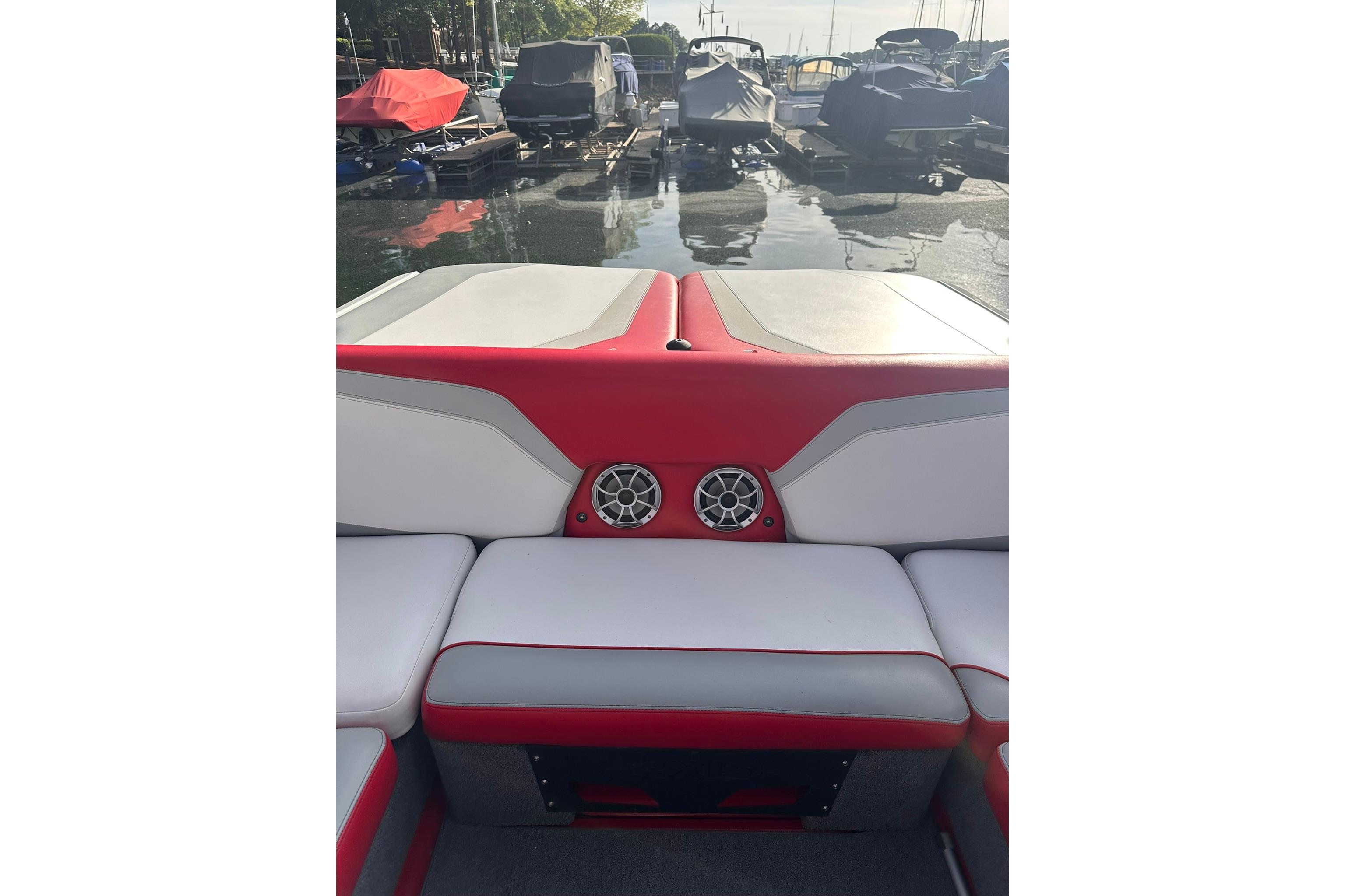 2017 Axis T23 boat interior with red and white seating, docked at marina.