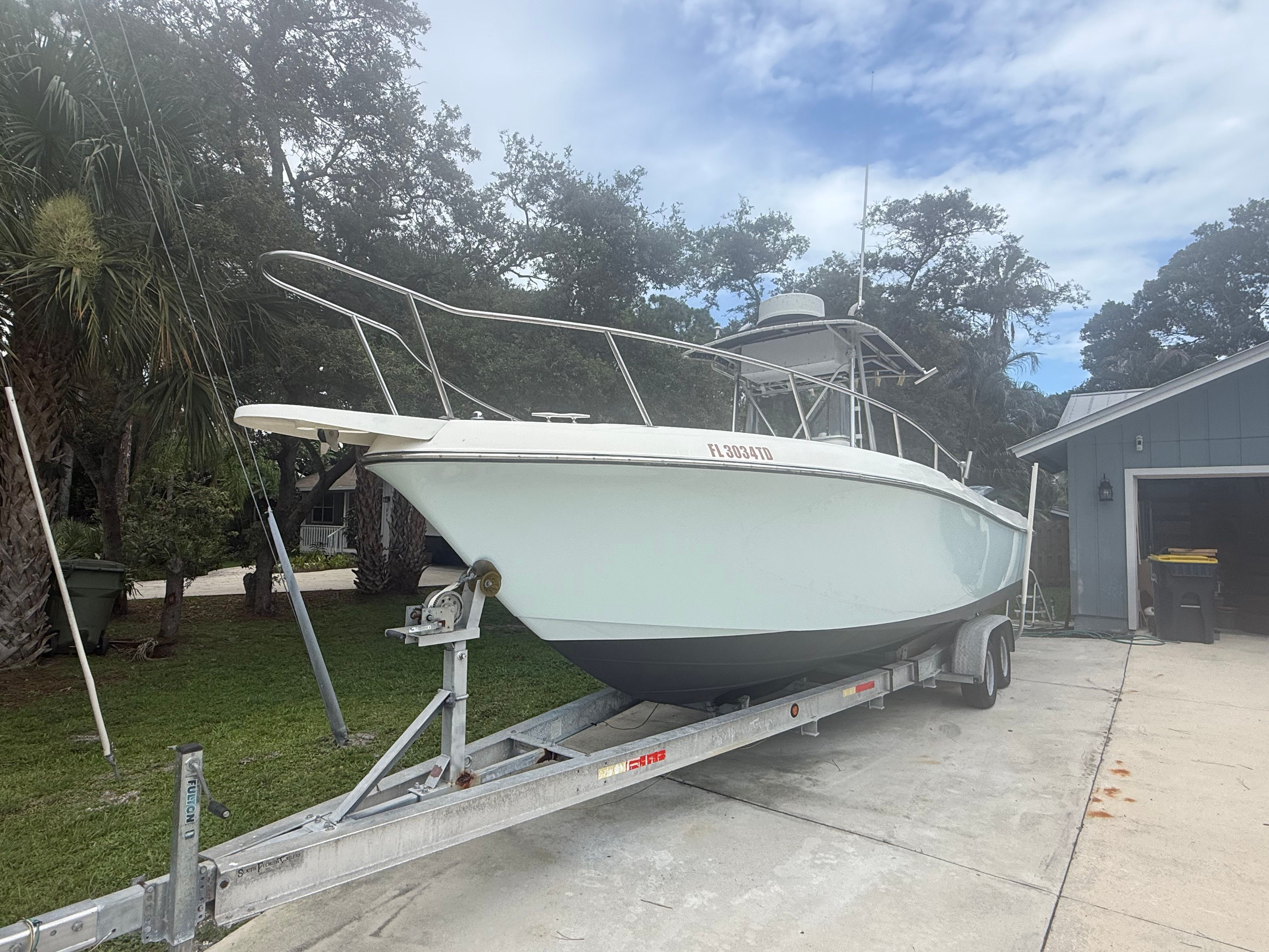 A 1994 Hydra-Sports Vector 2550 cc boat on a trailer in a driveway.
