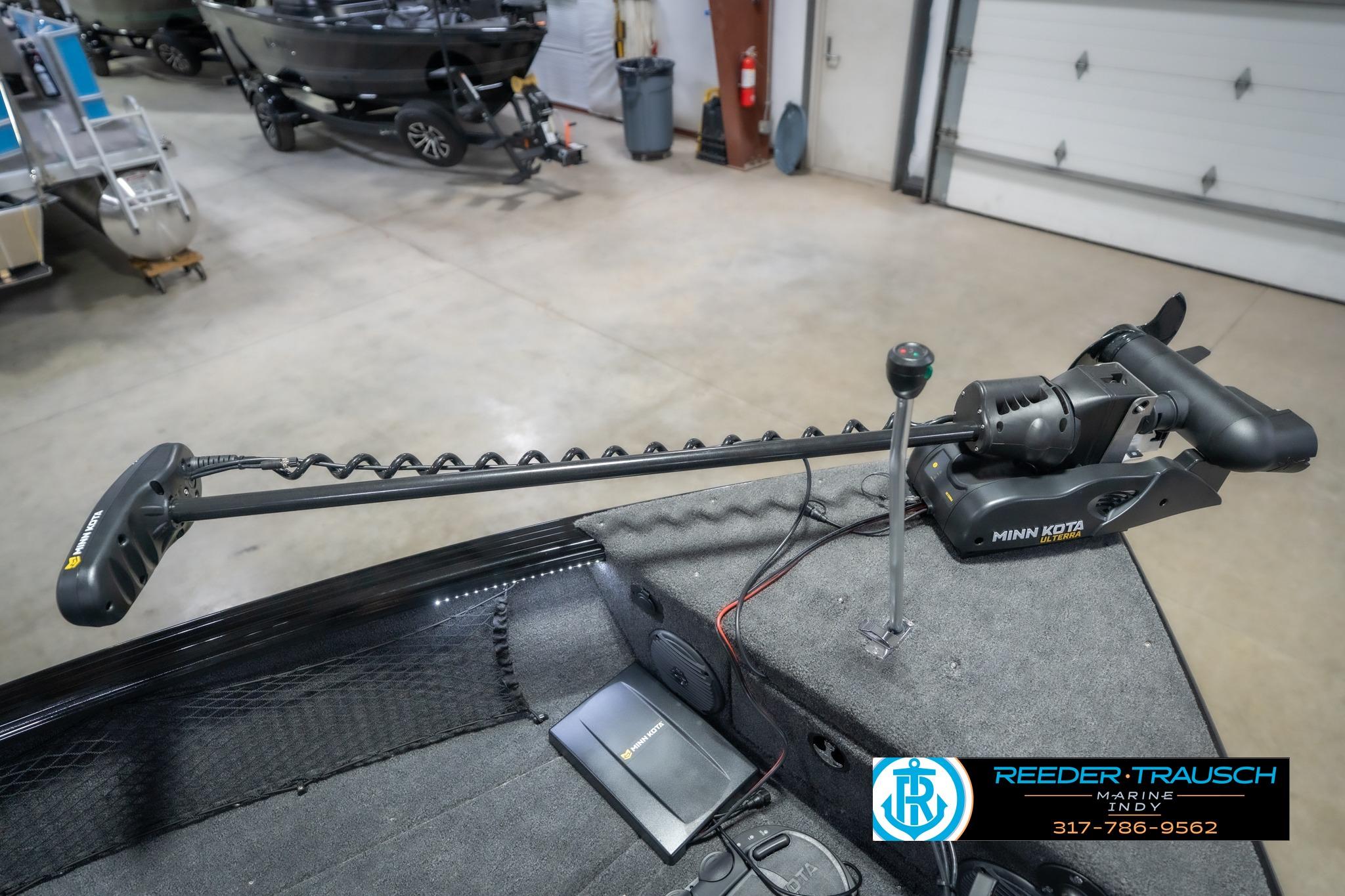 2026 Lund 2075 Impact XS boat with Minn Kota trolling motor in showroom.