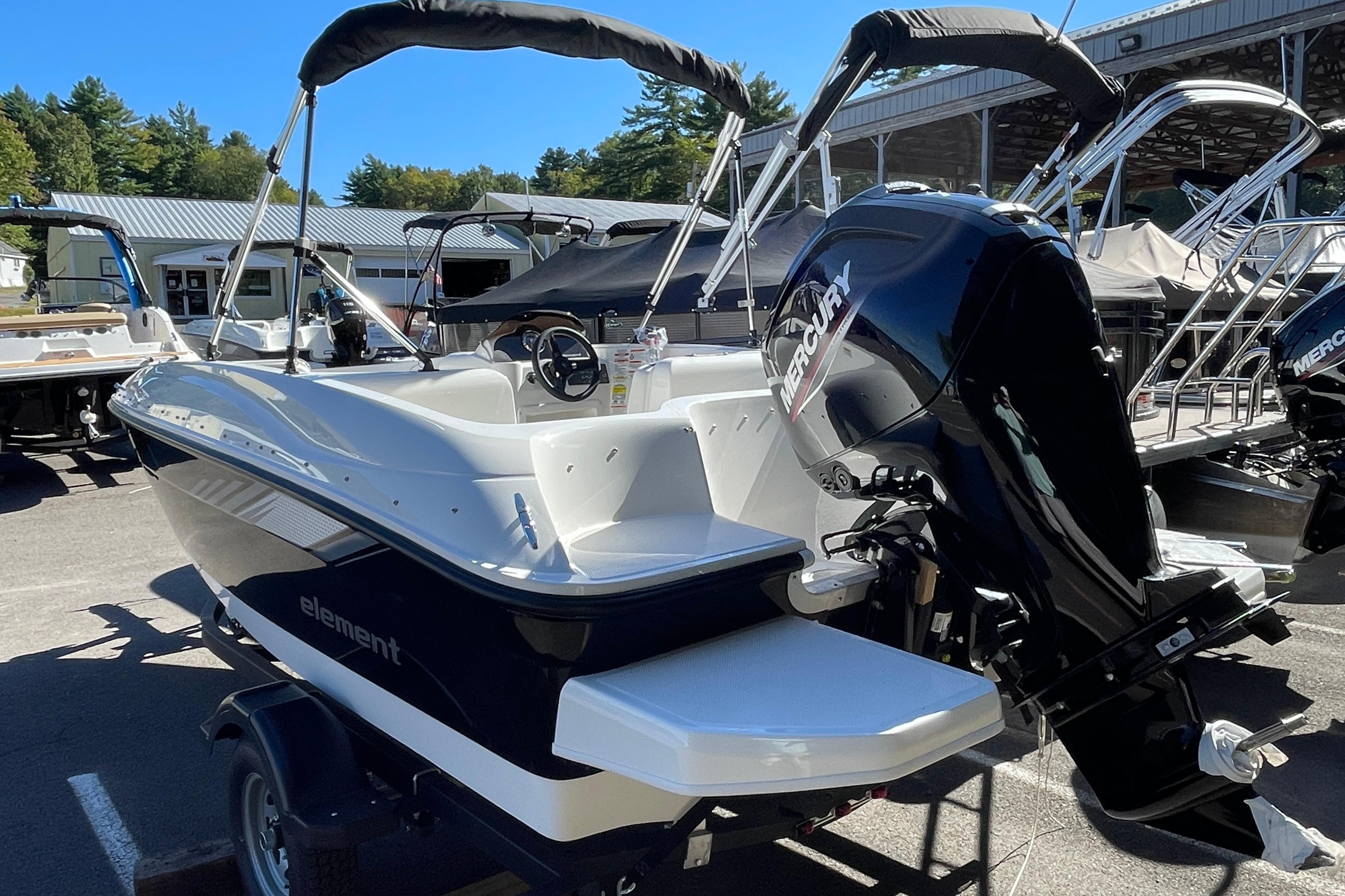 2026 Bayliner Element E16 boat with Mercury engine, parked outdoors.