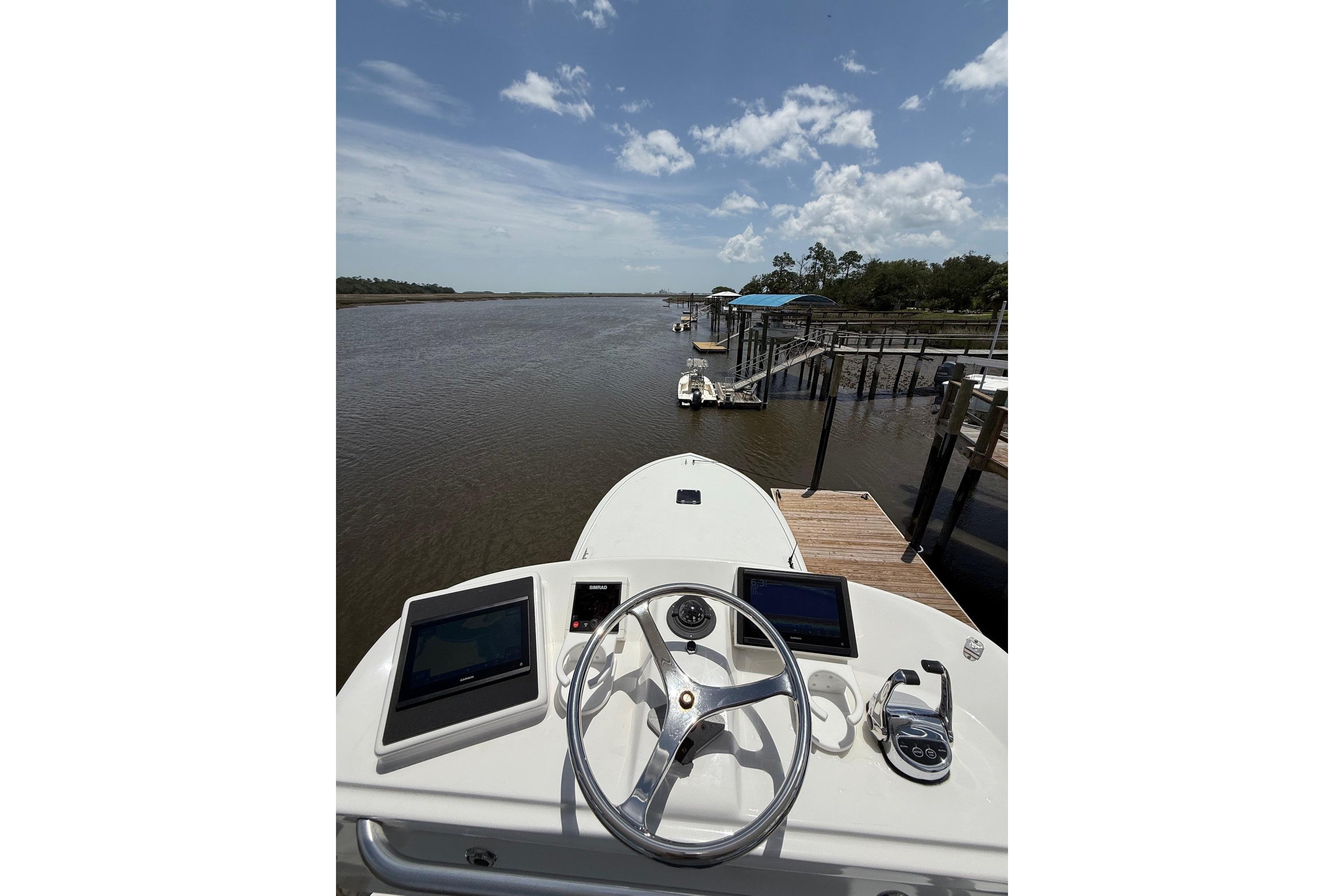 2006 Custom Carolina Heritage Express boat at dock, river view, clear sky.