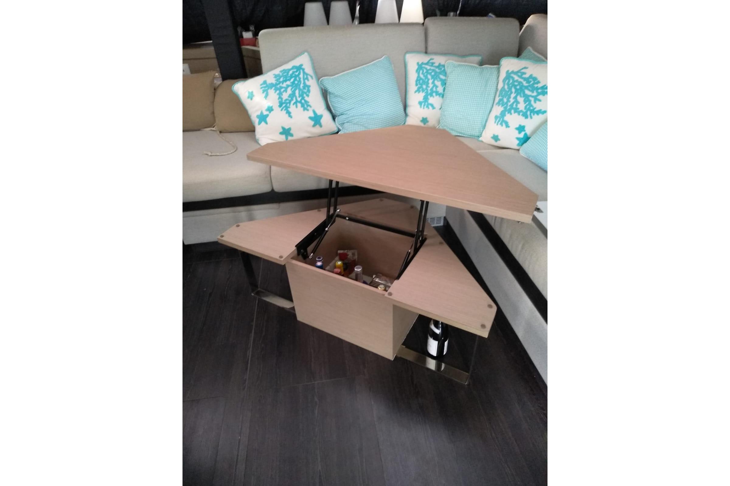 Interior of 2020 Fountaine Pajot Saona 47 with a convertible table and decorative cushions.