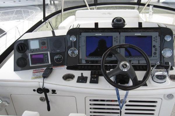 2008 Sea Ray 47 Sedan Bridge helm with dual navigation screens and control panel.