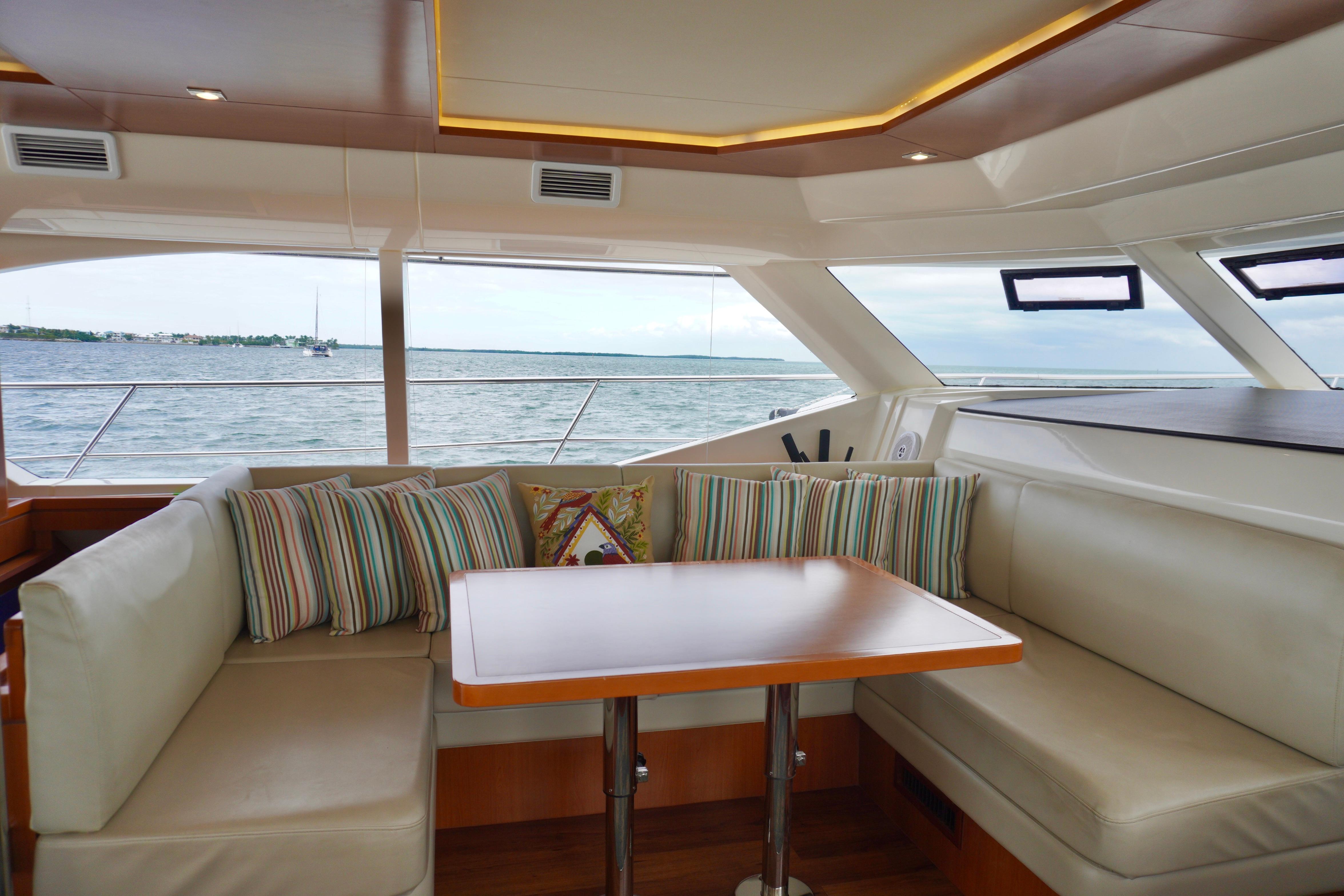 Luxurious interior of 2017 Aquila 44 Yacht with ocean view and cozy seating area.