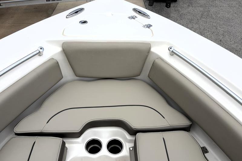 2024 Key West 239 FS boat interior with cushioned seating and cup holders.