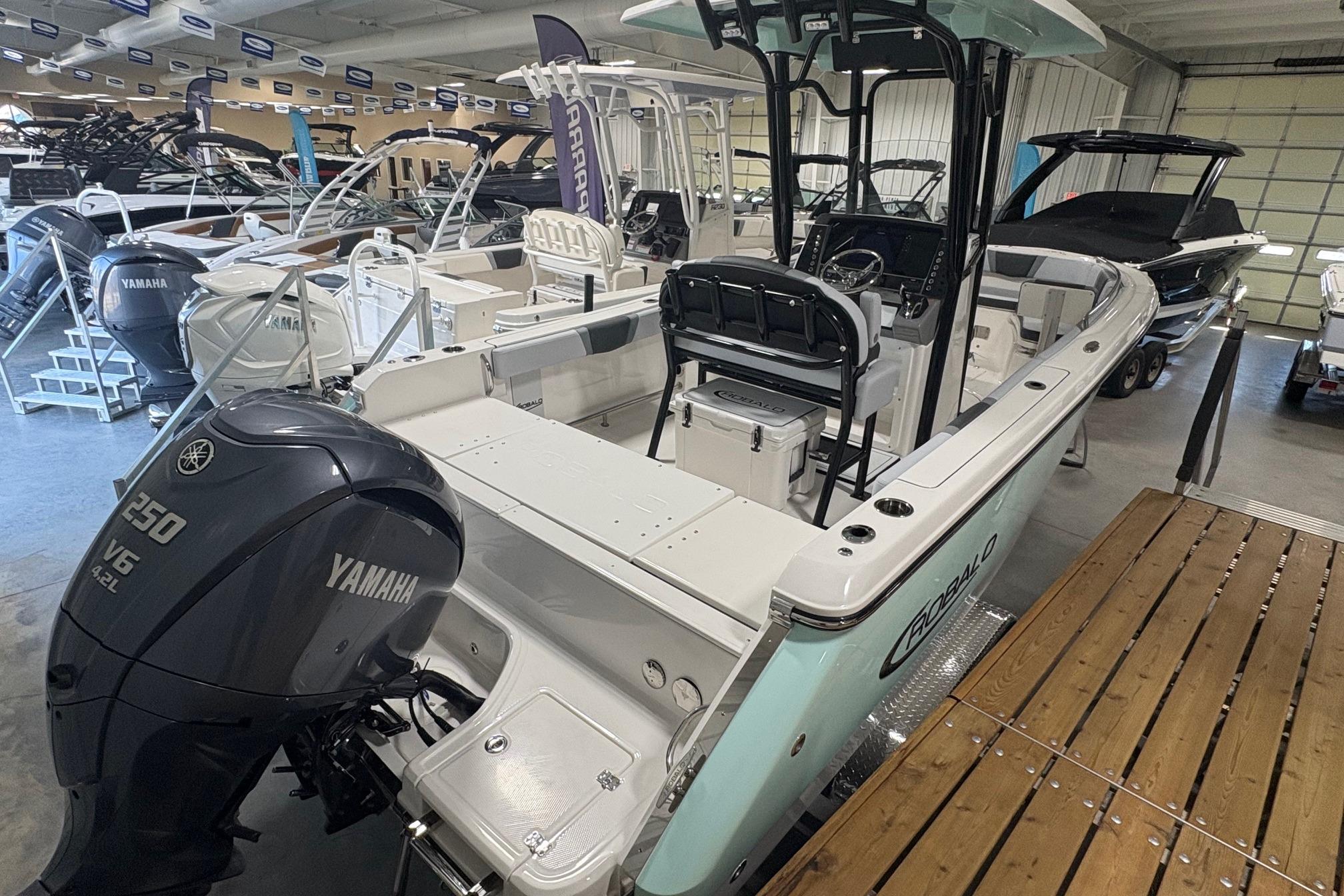 2025 Robalo R232 Explorer boat with Yamaha 250 V6 engine in showroom.