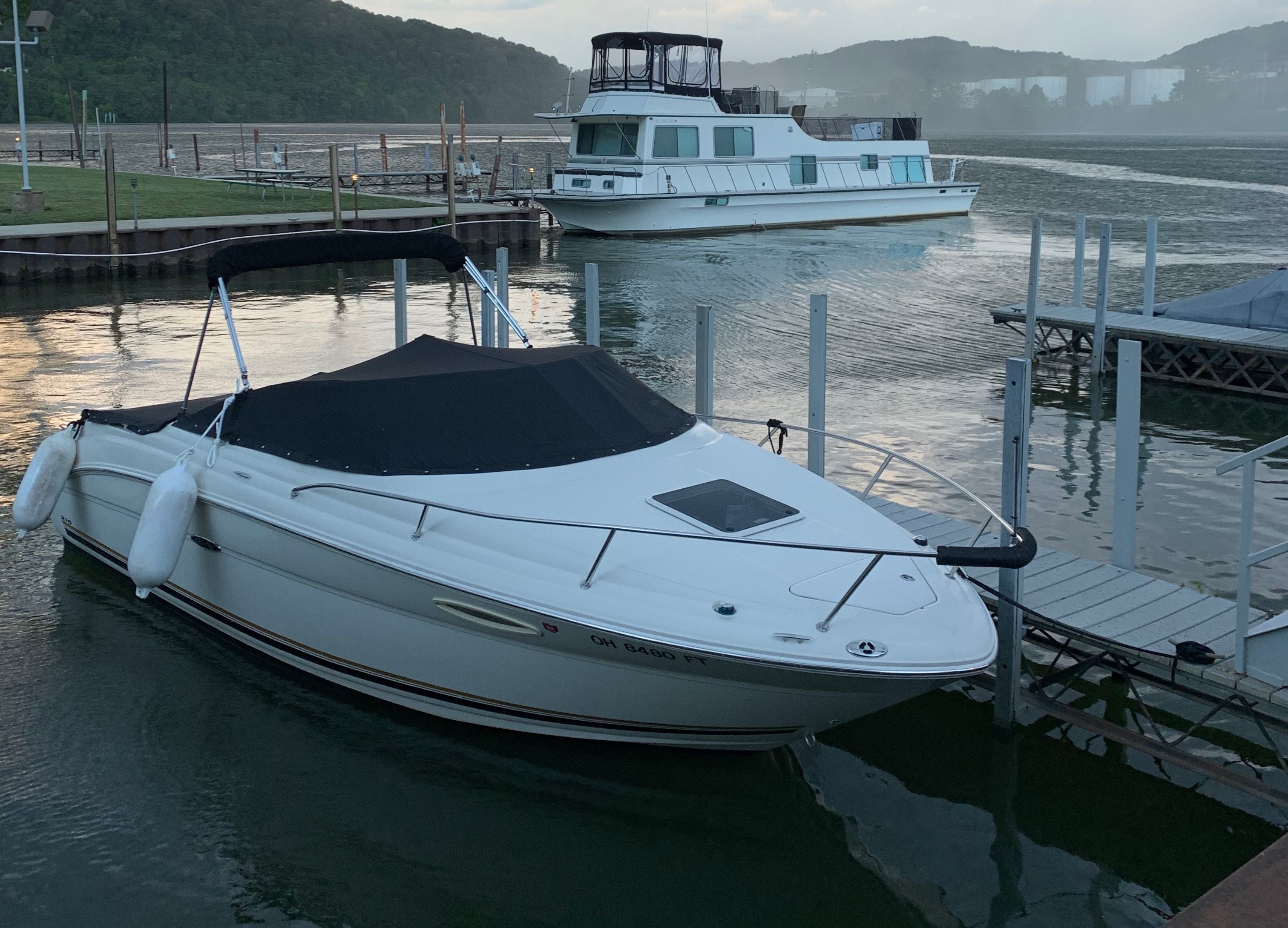2006 Sea Ray 215 Weekender docked on calm water.