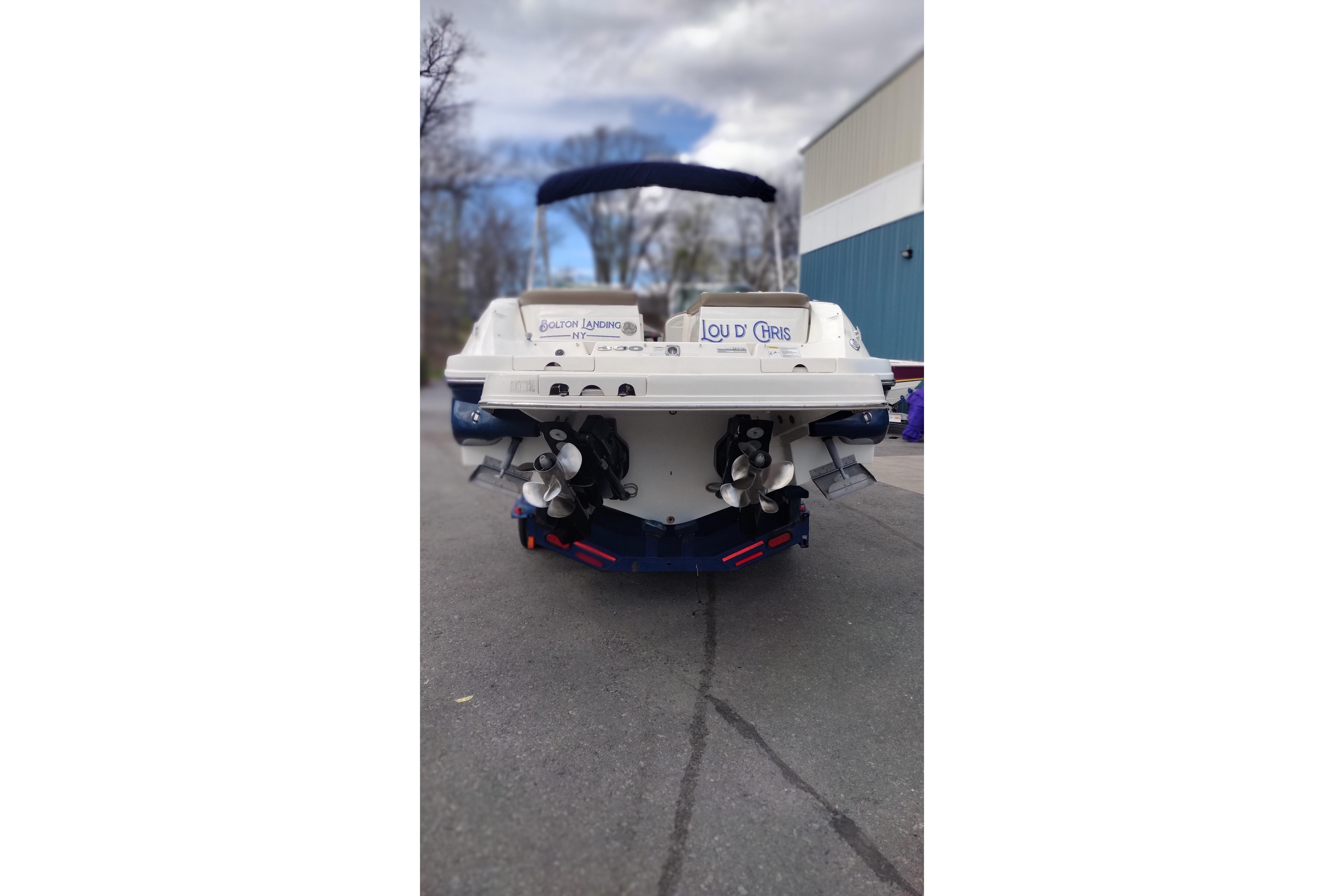 Rear view of a 2013 Sea Ray 300 SLX boat parked outdoors.
